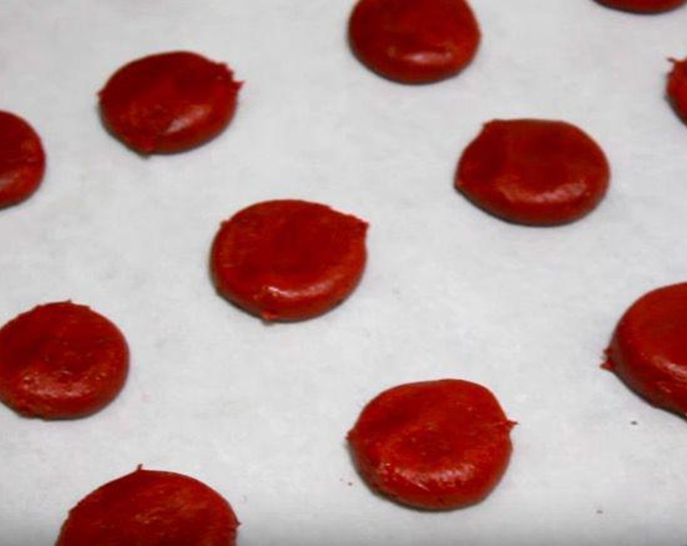 step 5 Take tablespoons of the dough and roll them into small balls. Place on a baking sheet lined with parchment paper. Press down gently to form dough balls into more circular shapes.