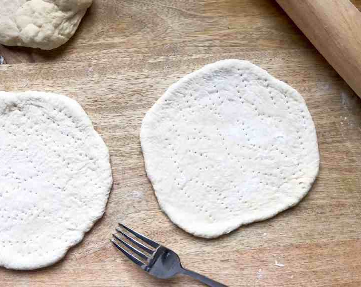 step 3 Dust the surface with All-Purpose Flour (as needed), roll each piece of dough into a 6 to 7-inch circle. Pierce liberally with the tines of a fork.