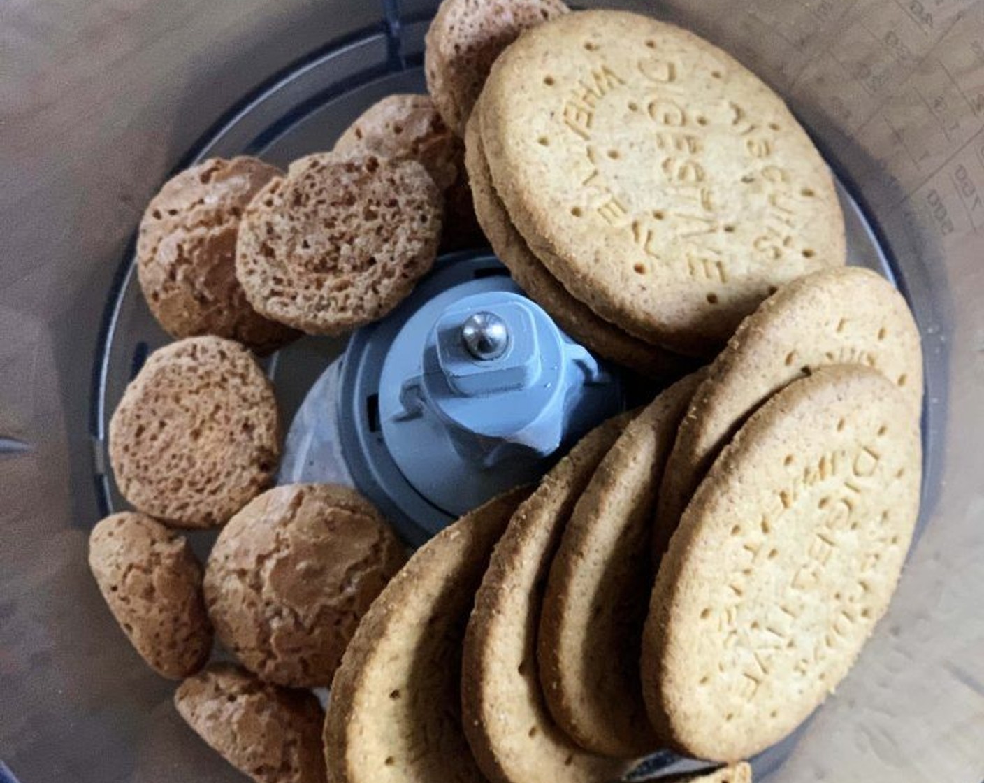 step 1 Start off by placing the Digestive Biscuit (1 cup) and Amaretti Biscuits (1/3 cup) into a food processor and pulse them until powdered.