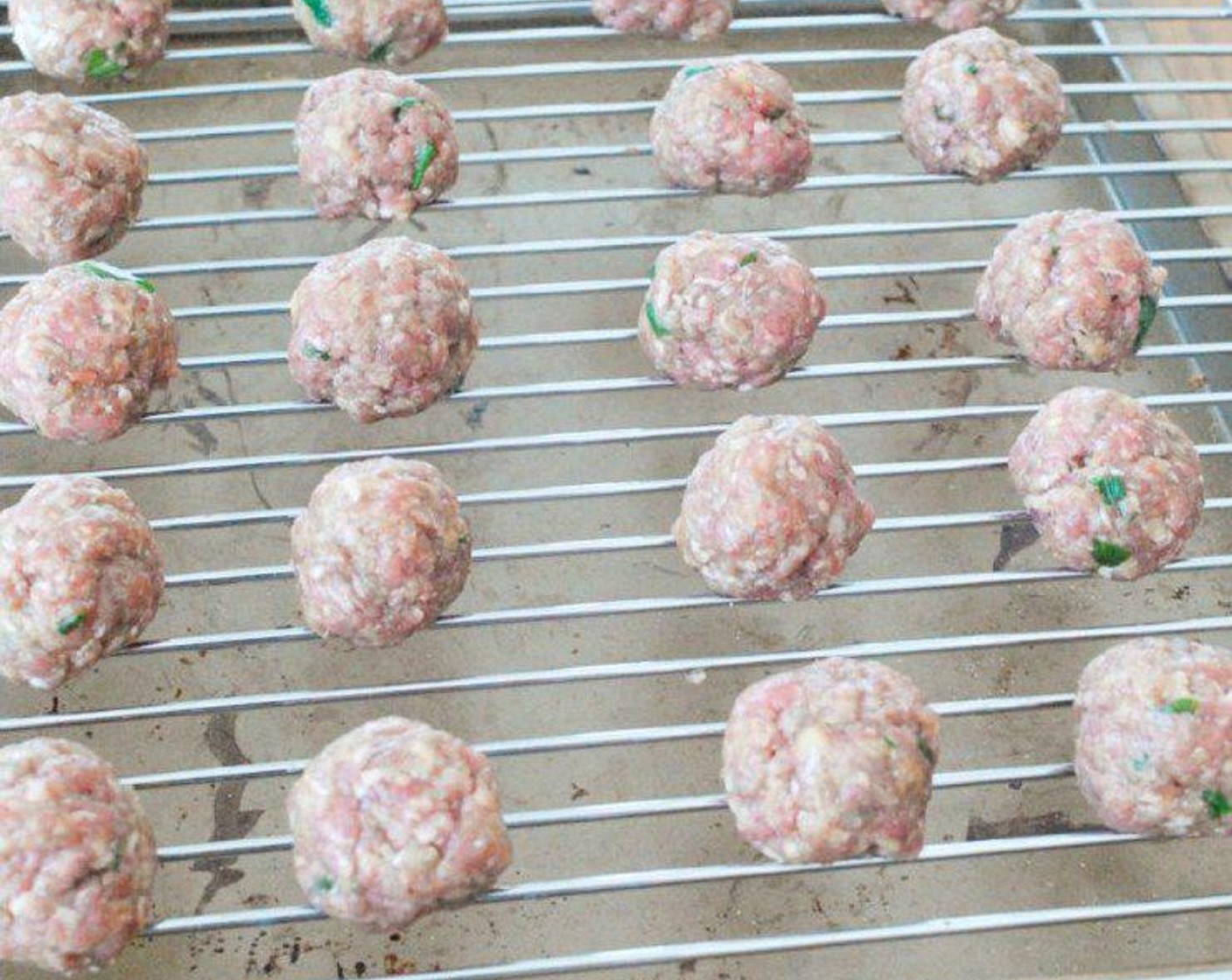 step 3 Take out a small portion of meat, roll into balls then place on the rack on top of a baking tray.