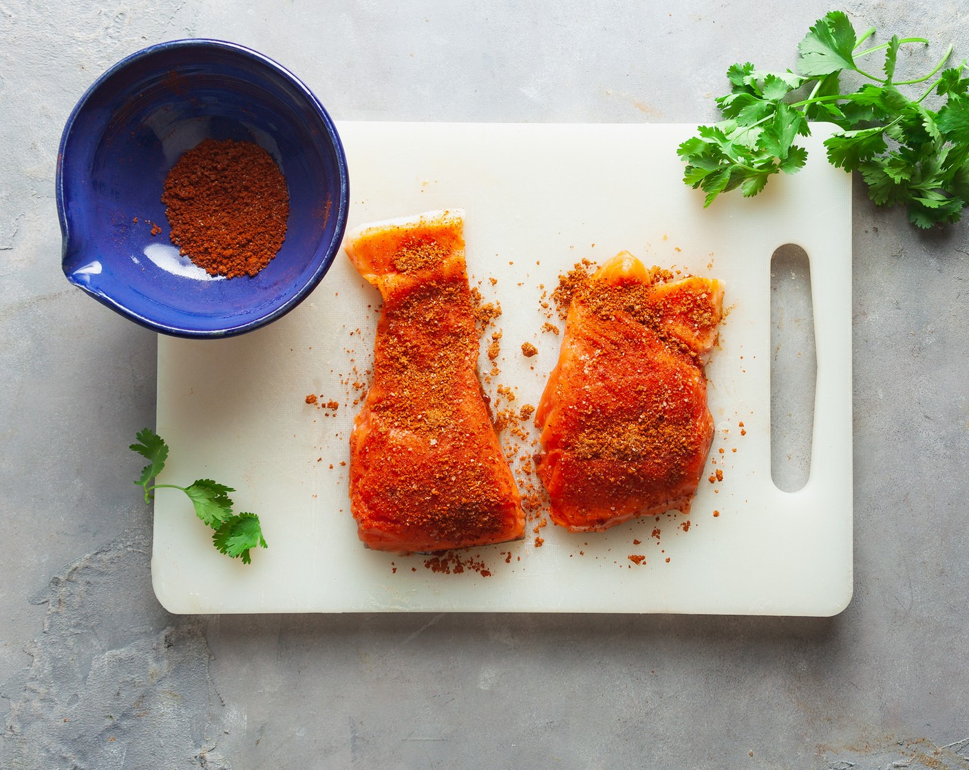 step 3 Place the Salmon Fillets (4) on a cutting board. Pat dry with a paper towel, then rub each portion generously with the spice rub.