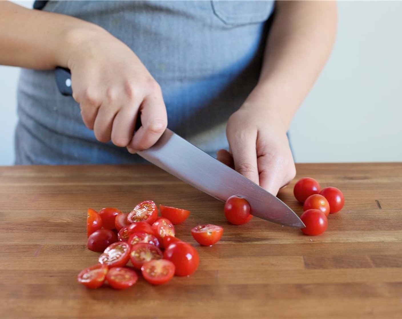 step 2 Meanwhile, juice Lemon (1) into a small bowl. Remove the seeds and set aside. Pick Fresh Basil (1/2 cup) leaves from stems and discard stems. Set leaves aside. Slice the Cherry Tomato (1 cup) in half lengthwise.