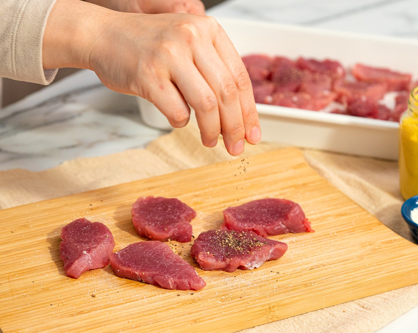 step 1 Das Schweinefilet (1.5 Pfund) in etwa 1 bis 1,5 cm dicke Scheiben schneiden. Mit feines Salz (1/2 TL) und Pfeffer, schwarz, gemahlen (1/4 TL) würzen.