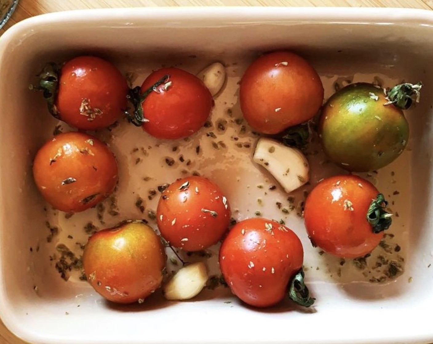 step 2 In a baking tray, place the Cherry Tomatoes (2 cups), Garlic (3 cloves), Dried Oregano (1/2 tsp), and Extra-Virgin Olive Oil (2 Tbsp). Toss everything together.