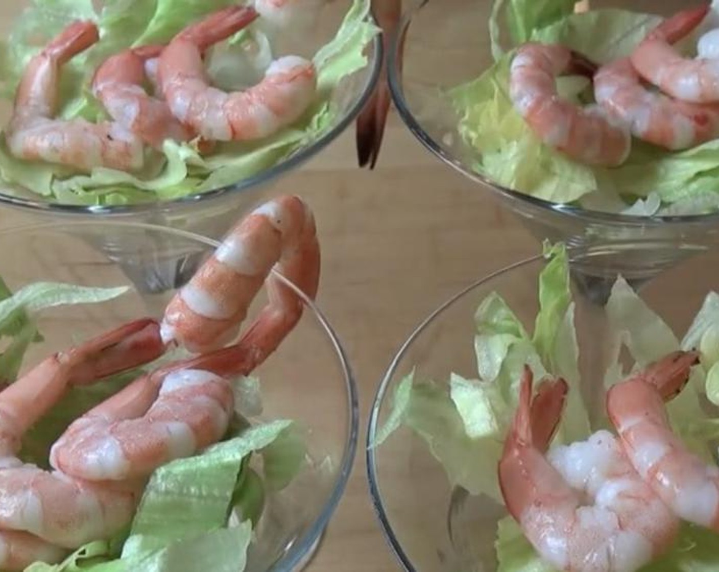 step 3 Place a little bit of Shredded Iceberg Lettuce (as needed) into each glass. Add the Prawns (1.3 lb) in the middle of each glass and add 1 hanging off the side for looks.