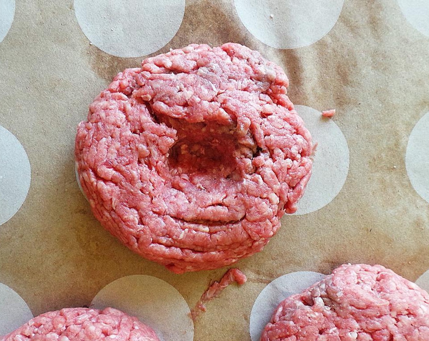 step 2 Using your thumb, create an indent in the center of each patty.