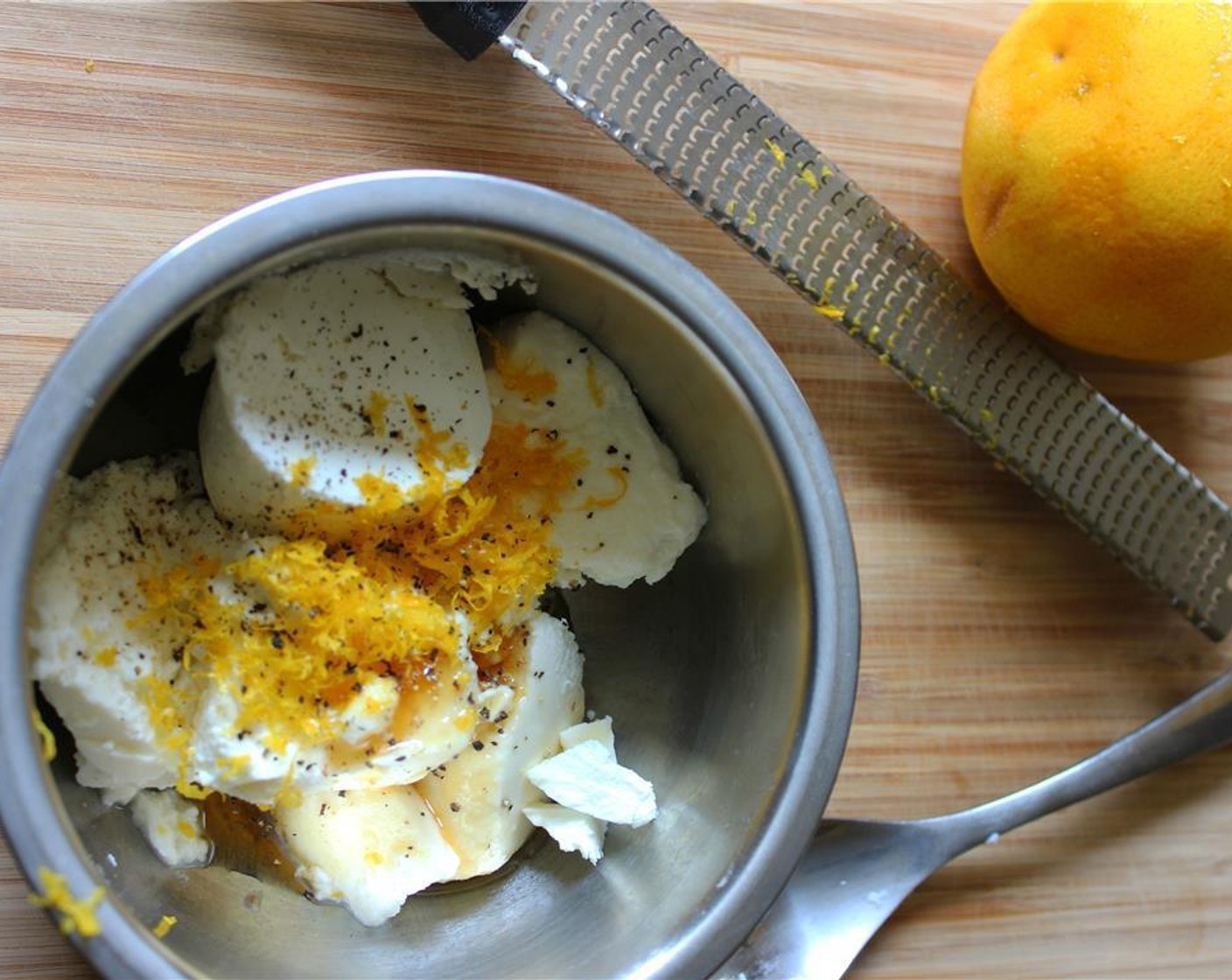 step 3 While tomatoes are in the oven, mix Ricotta Cheese (3/4 cup), Goat Cheese (1/3 cup), Honey (1 tsp), and Orange Zest (1/2) in a small bowl with cracked black pepper to taste.