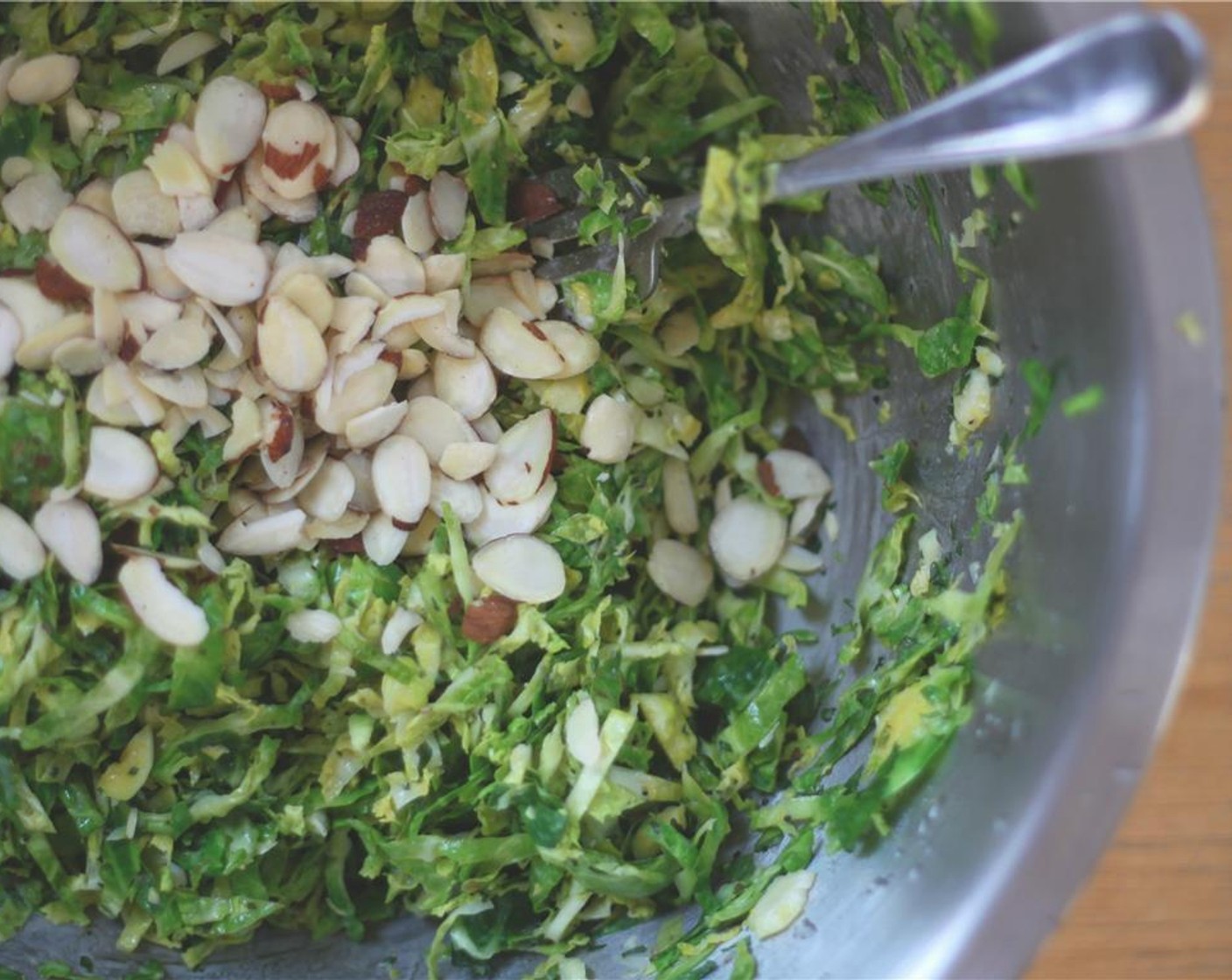 step 6 Toss the shredded sprouts in the dressing and add the remaining chopped mint and Slivered Almonds (1/4 cup).