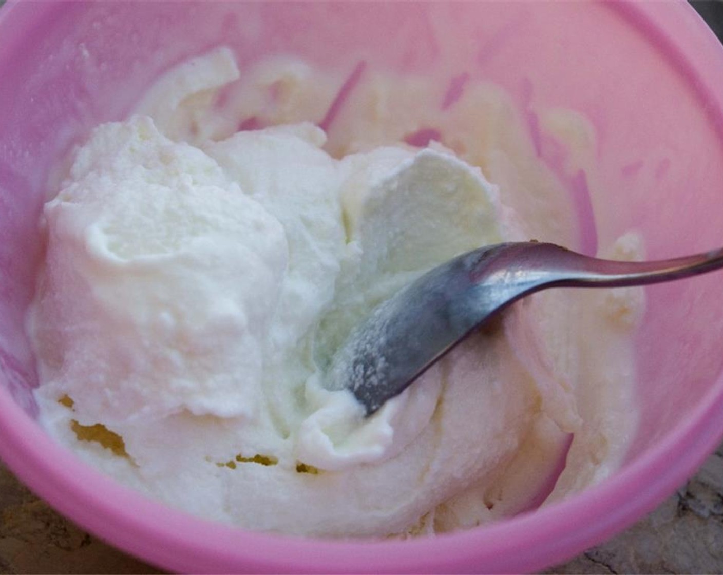 step 5 Next, take the vanilla ice cream and cream it by stirring it with a spoon.