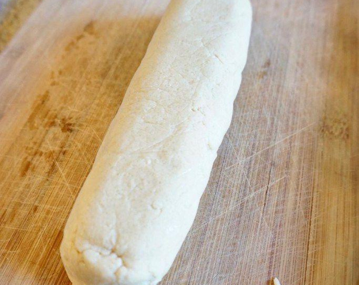 step 4 Transfer dough to a cutting board and roll into a long tube. Place in the center of a sheet of plastic wrap, then wrap and chill in the refrigerator for at least 1 hour, until dough is firm.