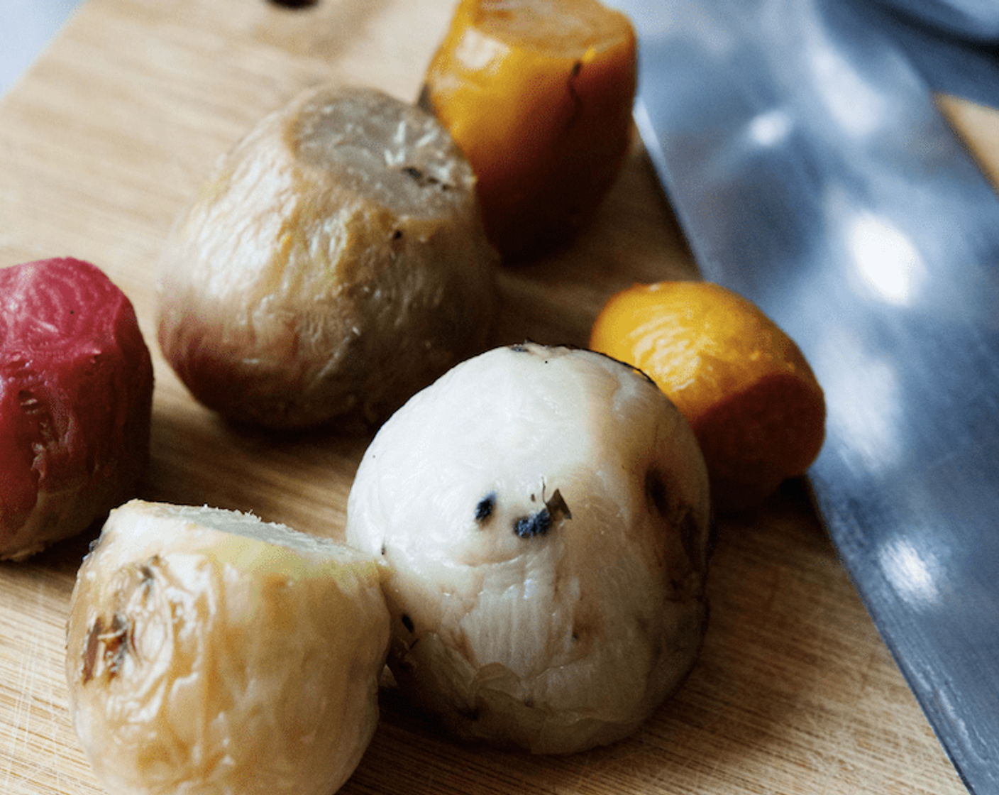 step 4 Remove them from the oven, put the purple one on the side and then peel and quarter the others.