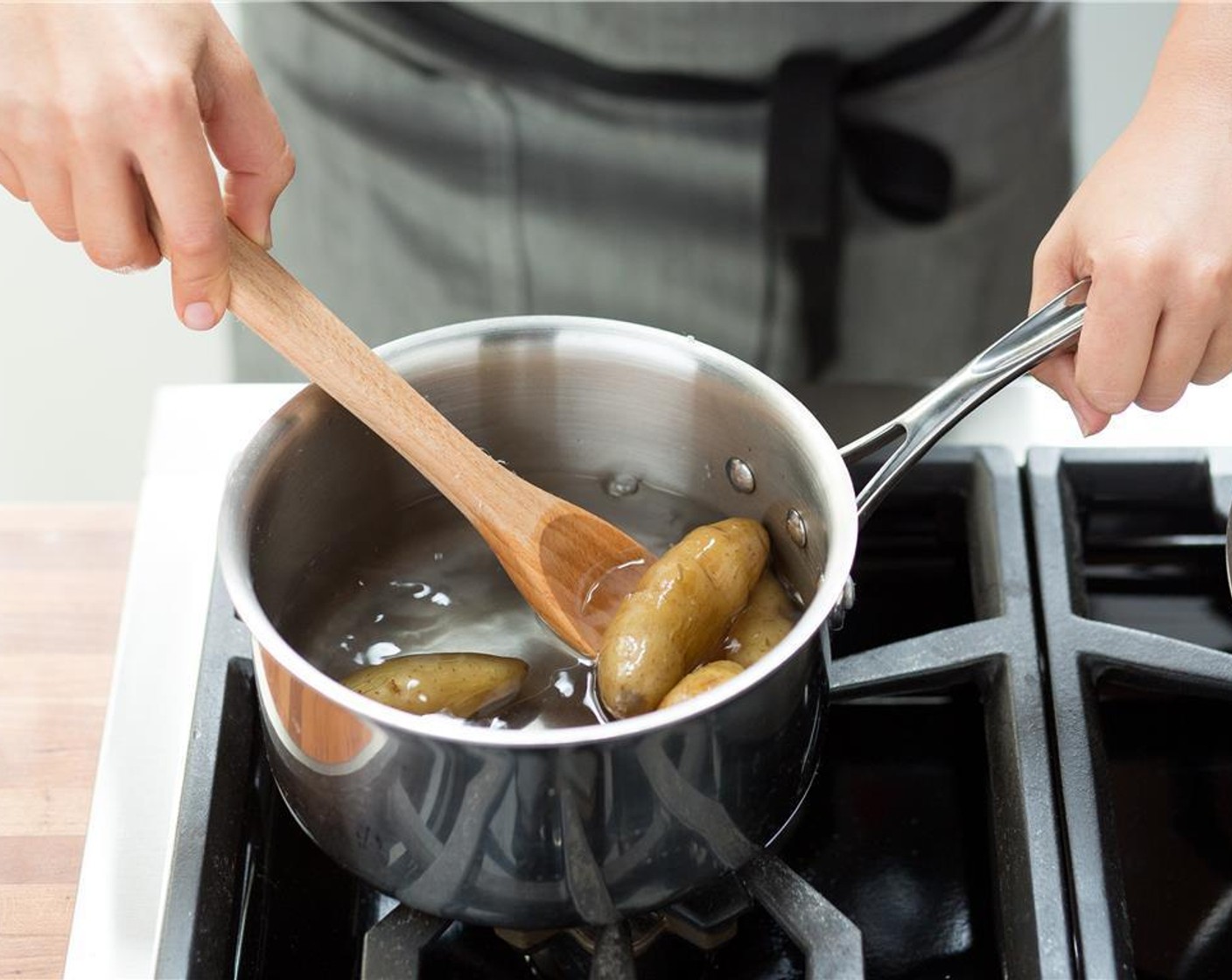 step 2 Put Fingerling Potatoes (1 1/2 cups) and Salt (1 tsp) in a medium saucepan and fill with enough water to cover potatoes. Place the pot over high heat and bring to a boil. Once the water is boiling, cook for 14 minutes, or until potatoes are fork tender.