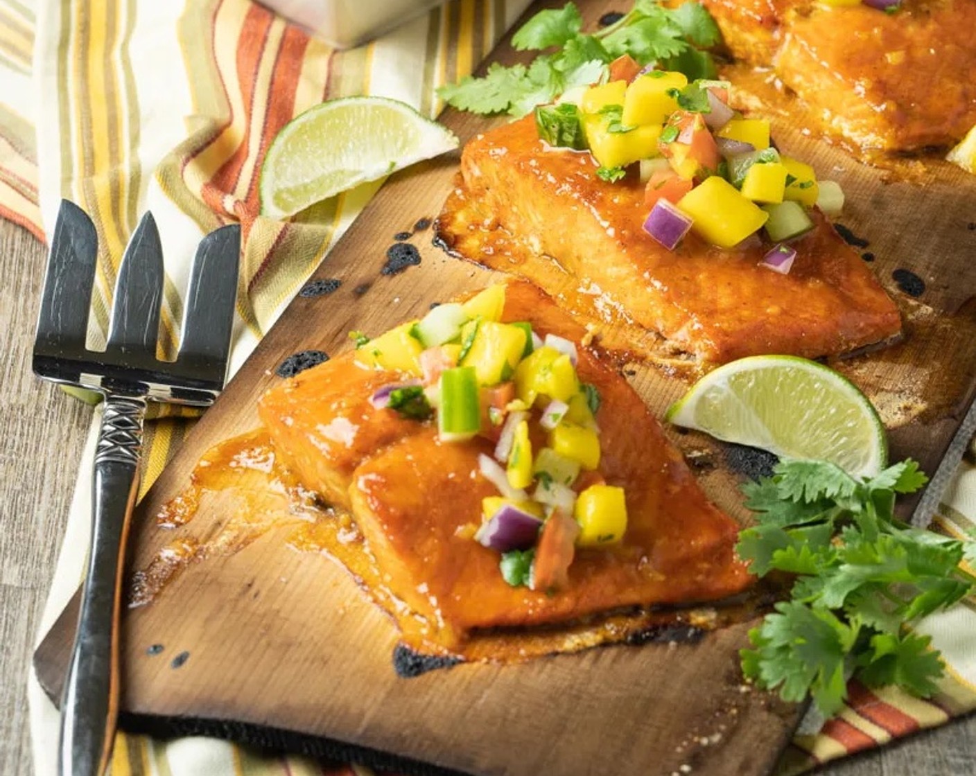 step 8 Remove salmon from the plank, cover and allow to rest for 5-10 minutes which will allow the fish to rise in temperature. Serve immediately with additional glaze and mango salsa.