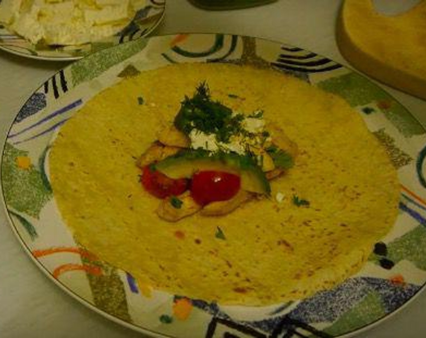 step 3 On top, place some Cherry Tomatoes (16), 3 slices of Avocado (1), Feta Cheese (1 2/3 cups), Salt (to taste), Some Fresh Dill (1 handful), Fresh Cilantro (1 handful), Limes (2), Chili Peppers (to taste) and wrap tight. Serve and enjoy!