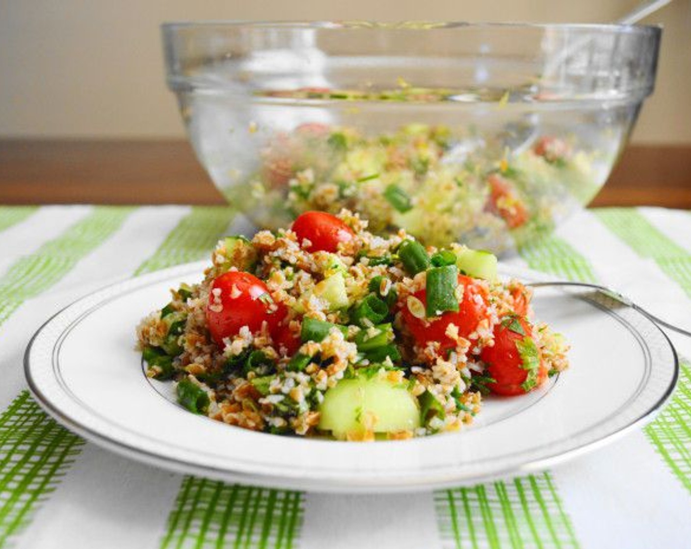 step 3 Add the Grape Tomatoes (20), Cucumber (1), Scallion (1 bunch), Fresh Parsley (1 bunch), Fresh Mint Leaves (16), zest and juice of the Lemons (2), Olive Oil (1/2 cup), and Salt (1 pinch). Toss it all together thoroughly and serve immediately! Enjoy!