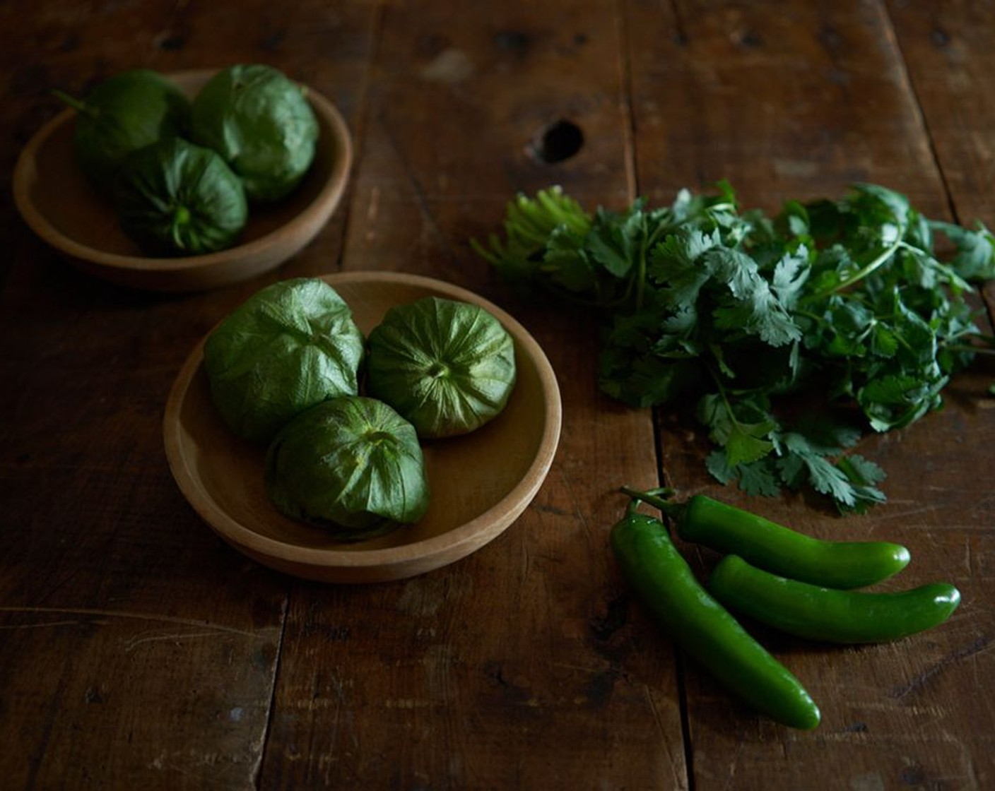 step 1 Remove husks and stems from Tomatillo (1 lb). Run them under warm water to remove the sticky residue. In a large pot, boil the tomatillos and Serrano Chili (1) in salted water for about 10-15 minutes until tender and cooked through.