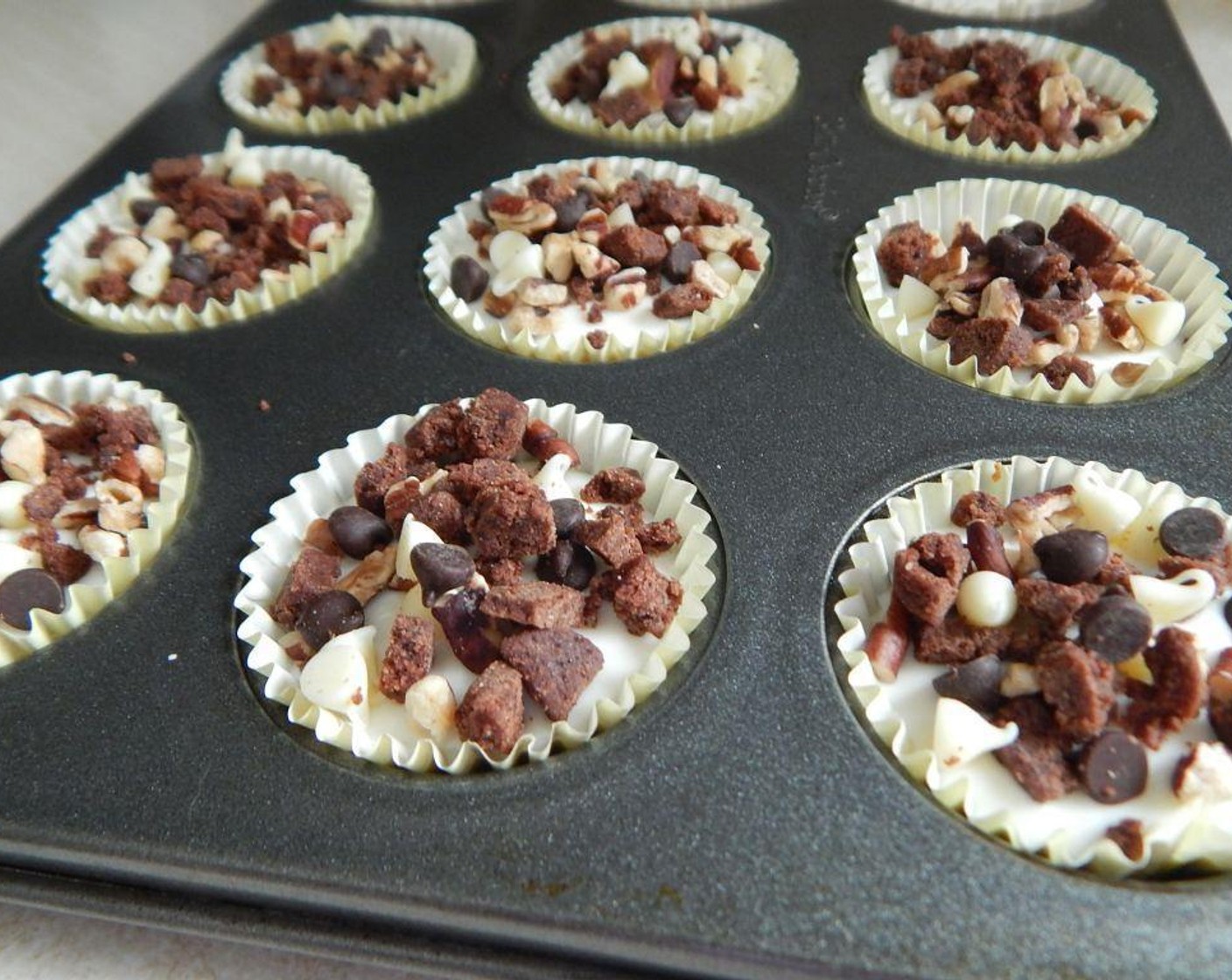 step 5 Divide your cream cheese mixture over the 18 mini muffin cups, about 1 tablespoon in each.