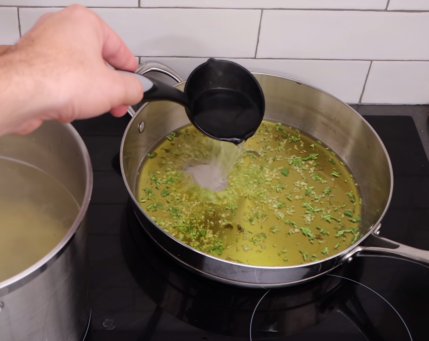 step 5 Once this has simmered for around 3-4 minutes, get a ladle full of pasta water and add it to the garlic mix.