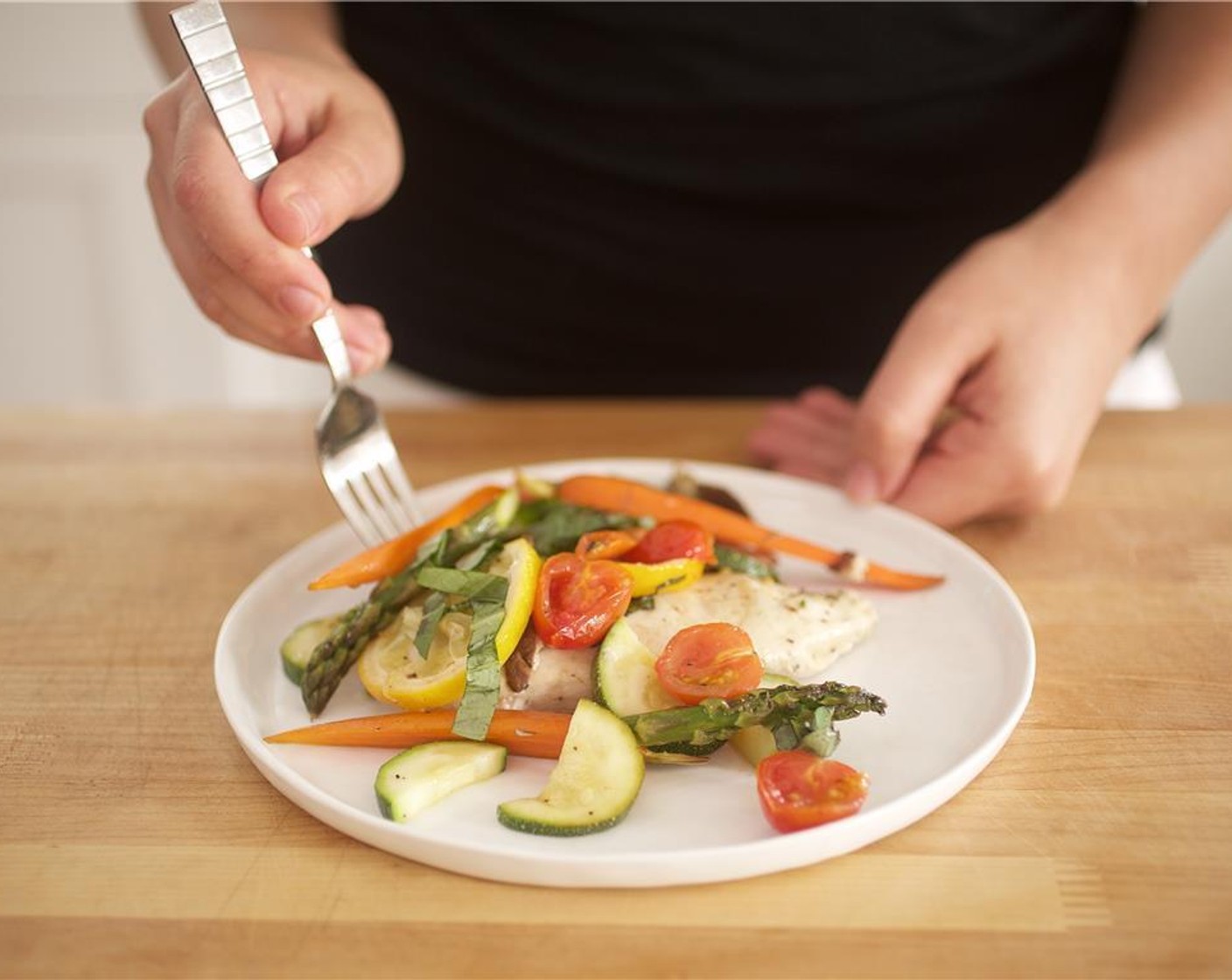 step 11 Carefully transfer chicken and vegetable mix from parchment to plates and garnish with reamining basil.