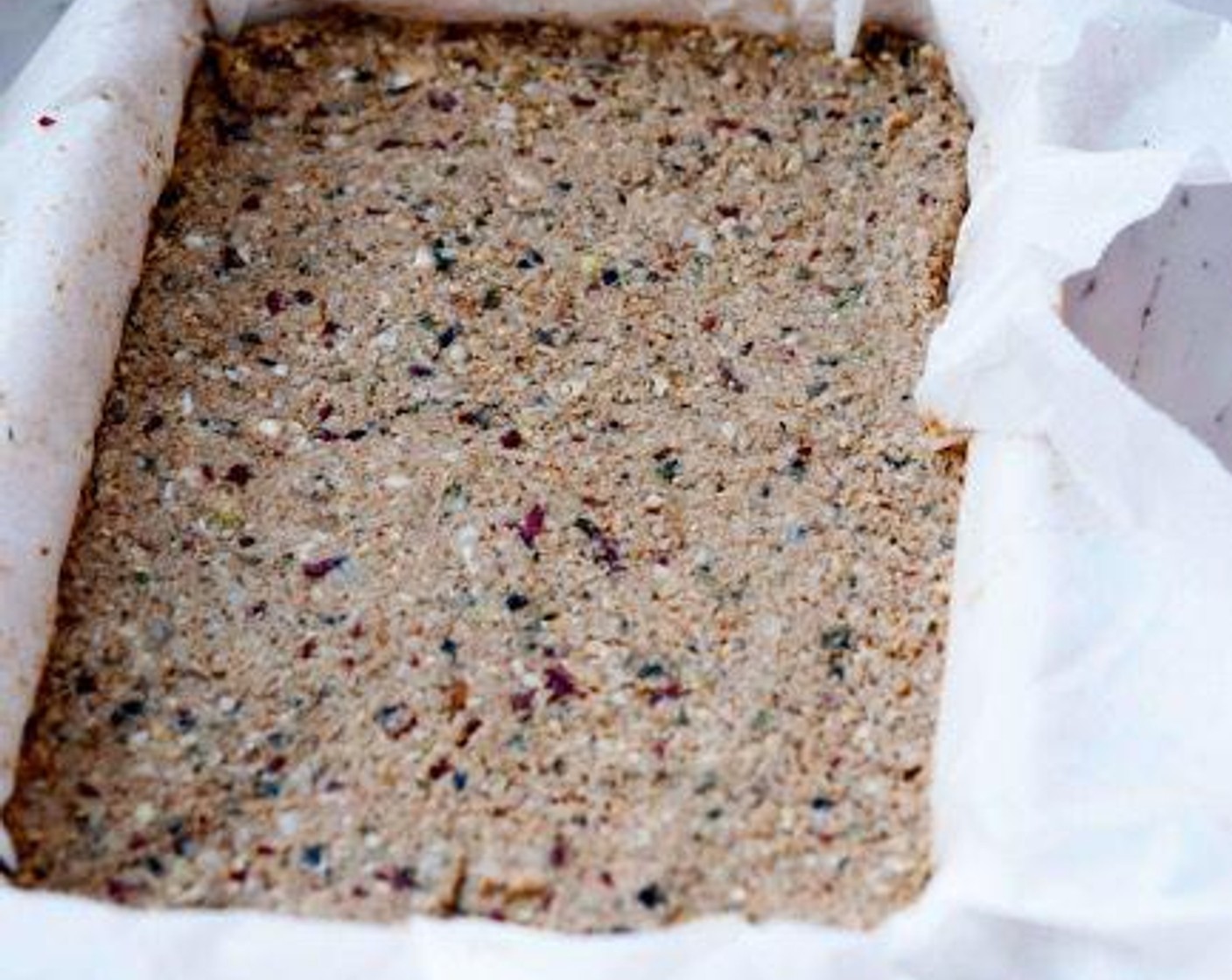 step 3 Press the mixture into a baking tray lined with parchment paper.