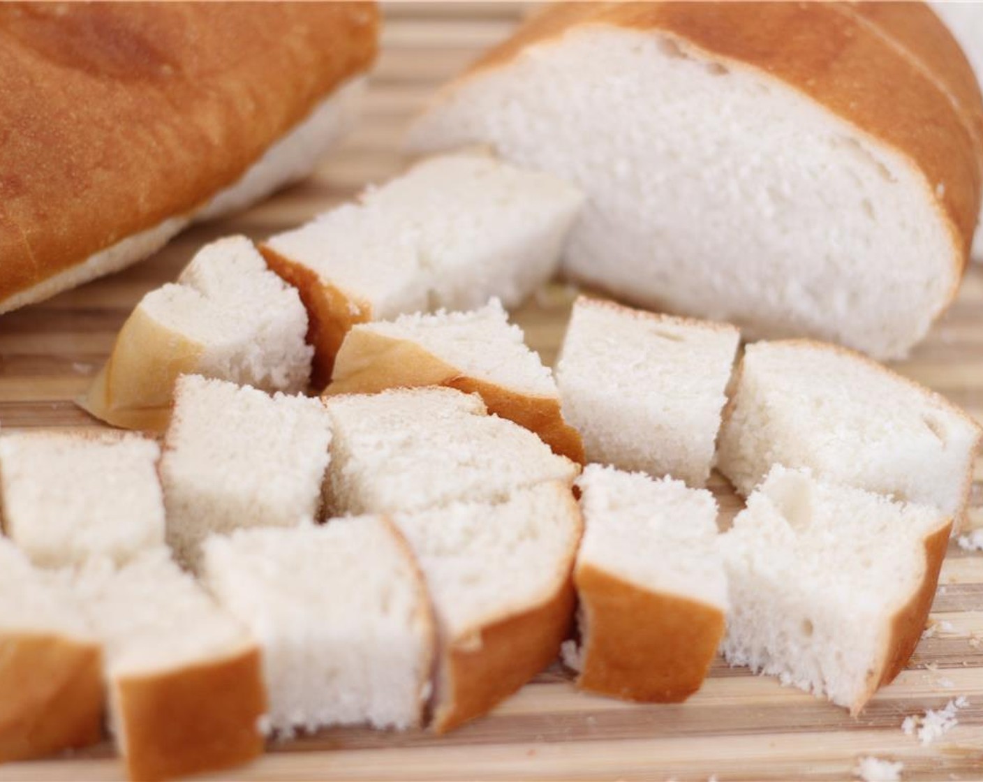 step 6 While the fondue is cooking over low heat, dice the French Bread (1 loaf) and slice the Granny Smith Apples (2).