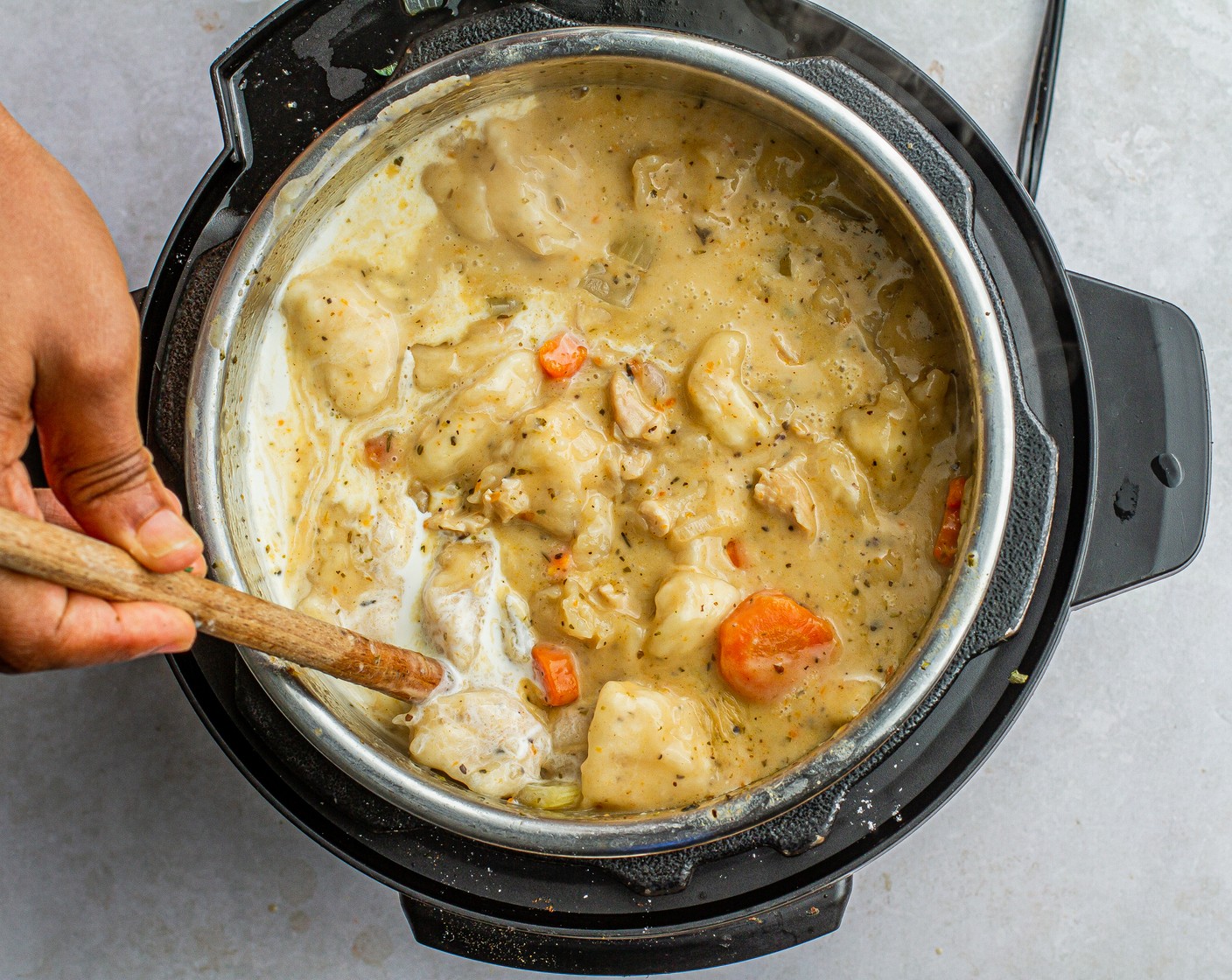 step 7 Stir in Heavy Cream (1 cup) and break up the dumplings. Spoon into bowls and garnish with Fresh Parsley (1/4 cup).