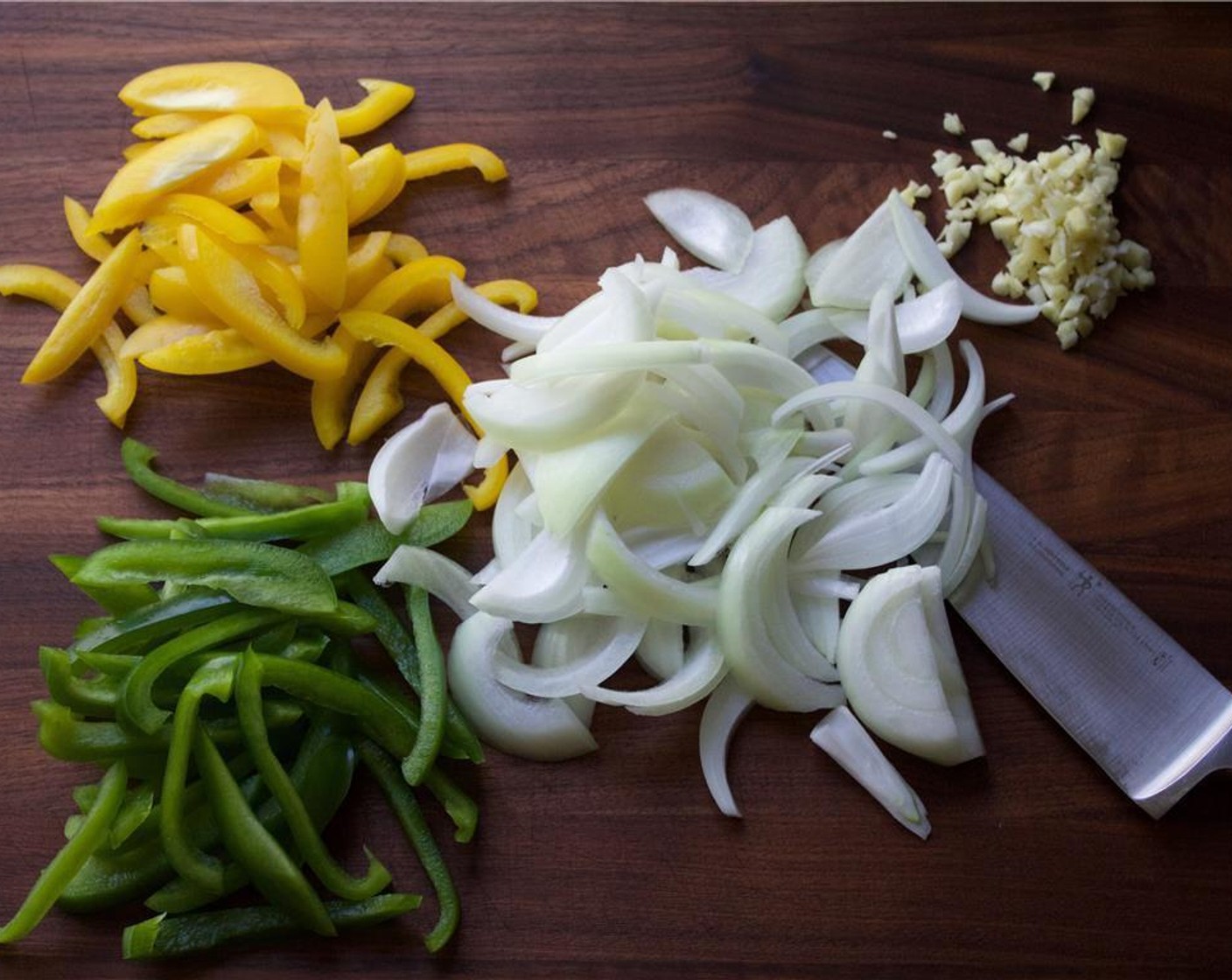 step 3 Julienne the Yellow Onion (1), Yellow Bell Pepper (1) and Green Bell Pepper (1). Peel and mince the Garlic (5 cloves).