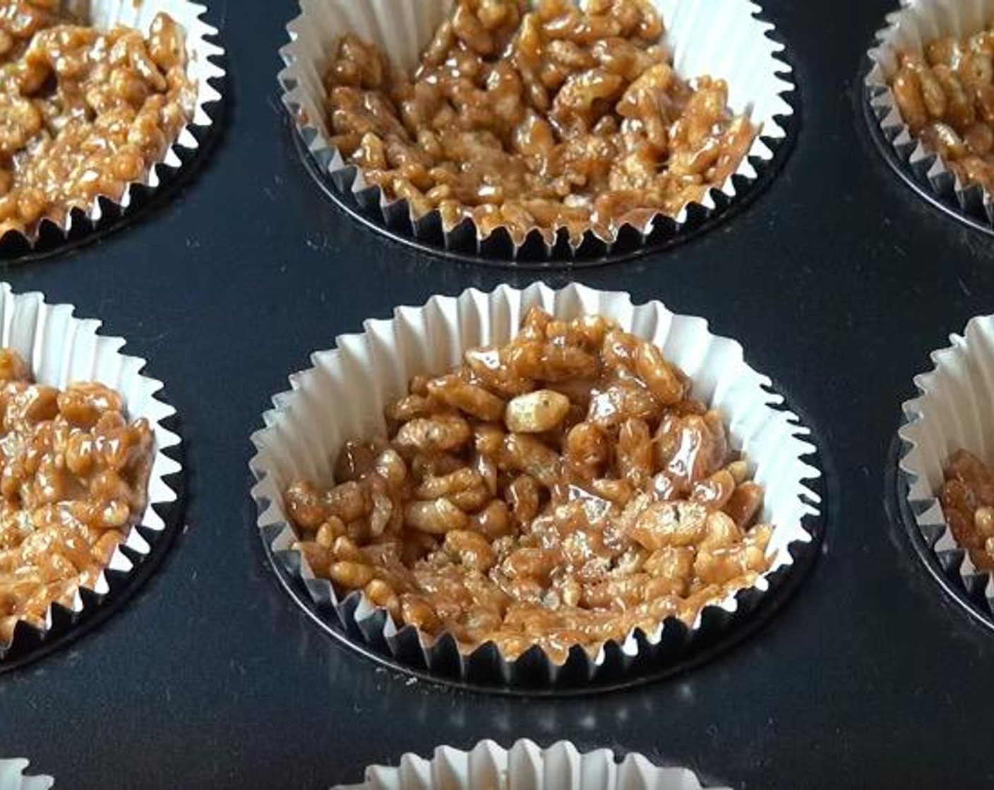 step 3 Transfer the mixture into a 12-hole muffin pan lined with paper cases. Push down the mixture in each cup with the back of a teaspoon to make a nest shape. Set aside to cool for 15 minutes.