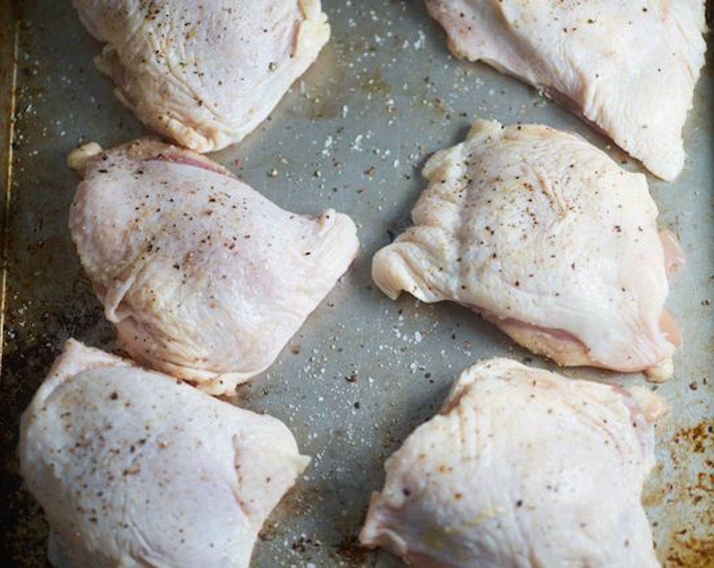 step 4 Dry the Bone-in, Skin-on Chicken Thighs (8) skin with a paper towel. Season the chicken thighs on both sides with Kosher Salt (to taste) and Freshly Ground Black Pepper (to taste).