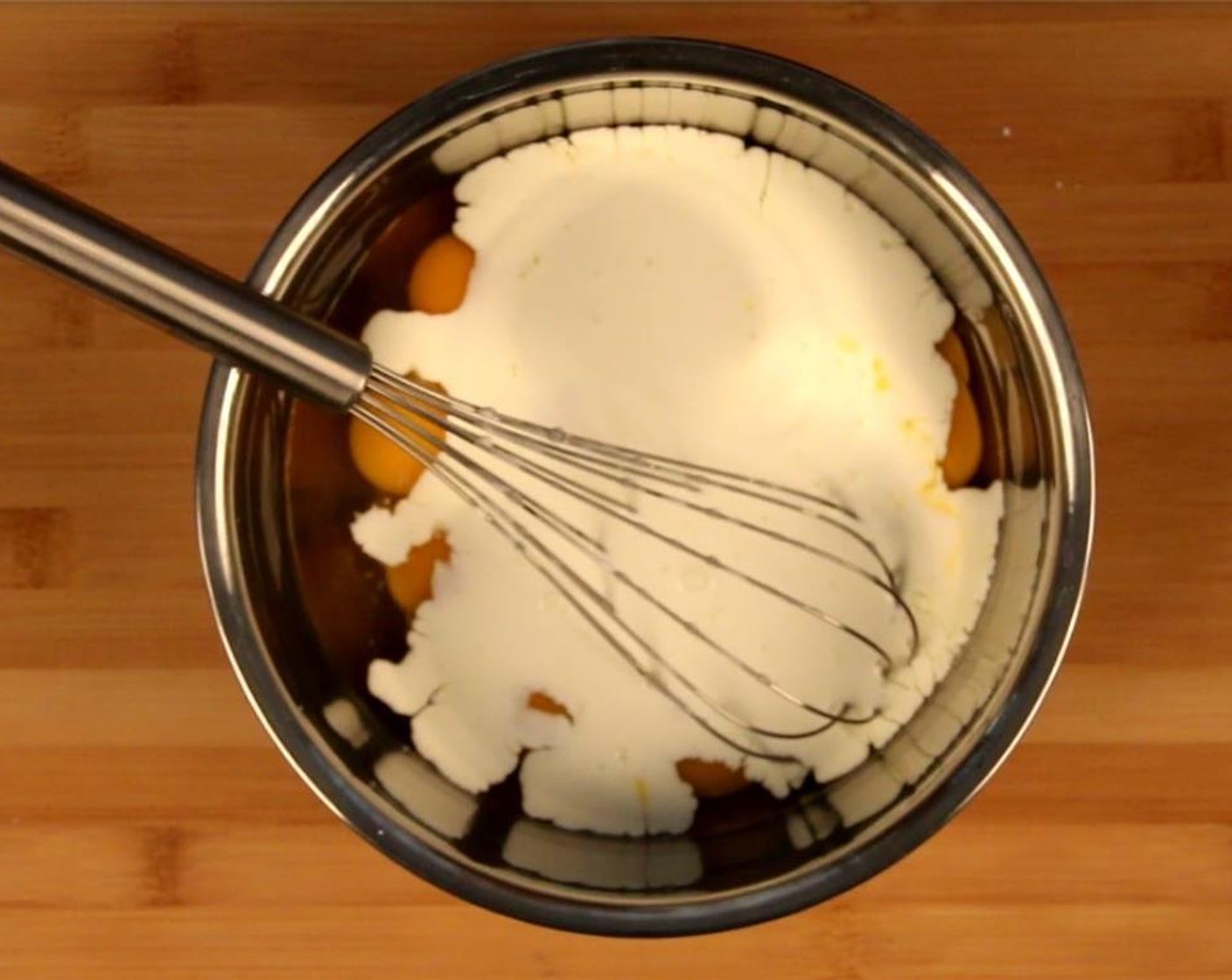 step 6 In a large bowl, add the Eggs (12), Heavy Cream (1/2 cup), and three-quarters of the Emmental Cheese (1 cup) and whisk together. Season with Salt (to taste) and Ground Black Pepper (to taste).