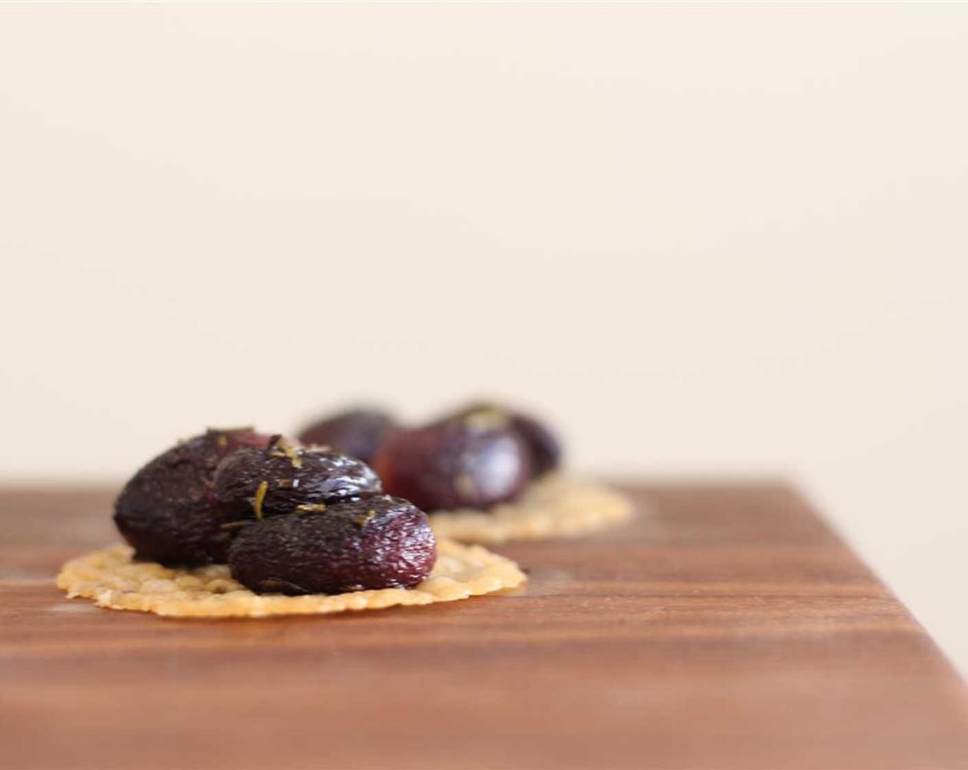 step 8 Arrange 2-3 cooled grapes on each crisp and drizzle with a bit of Honey (1/2 Tbsp). Serve and enjoy!