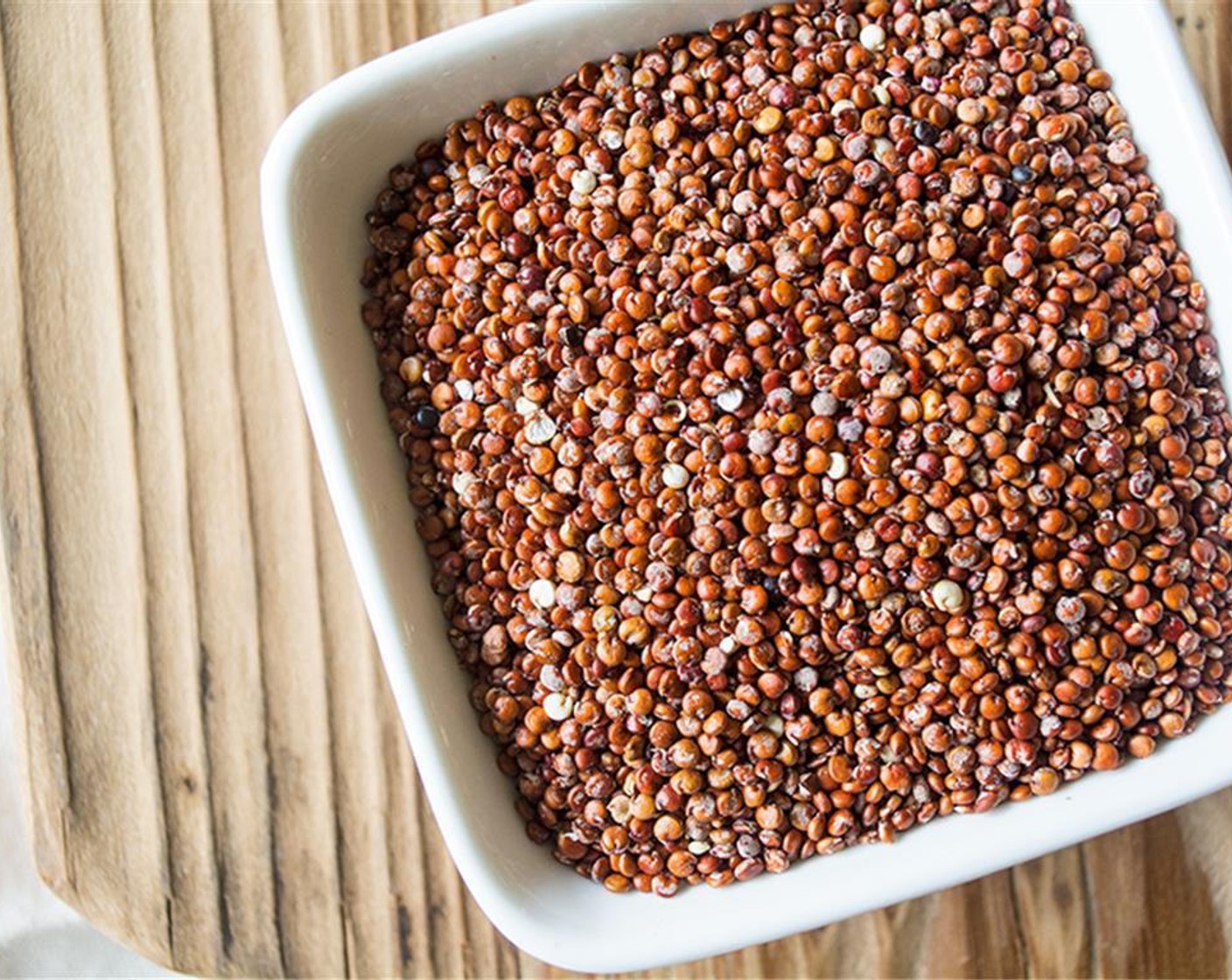 step 2 Thoroughly rinse the Red Quinoa (1/4 cup) to remove the saponin (bitter taste) by adding uncooked quinoa to bowl, fill with clean water and soak for a few minutes. Use a wire whisk to move the quinoa around in the water, then strain the quinoa in a fine mesh sieve and rinse with fresh water.