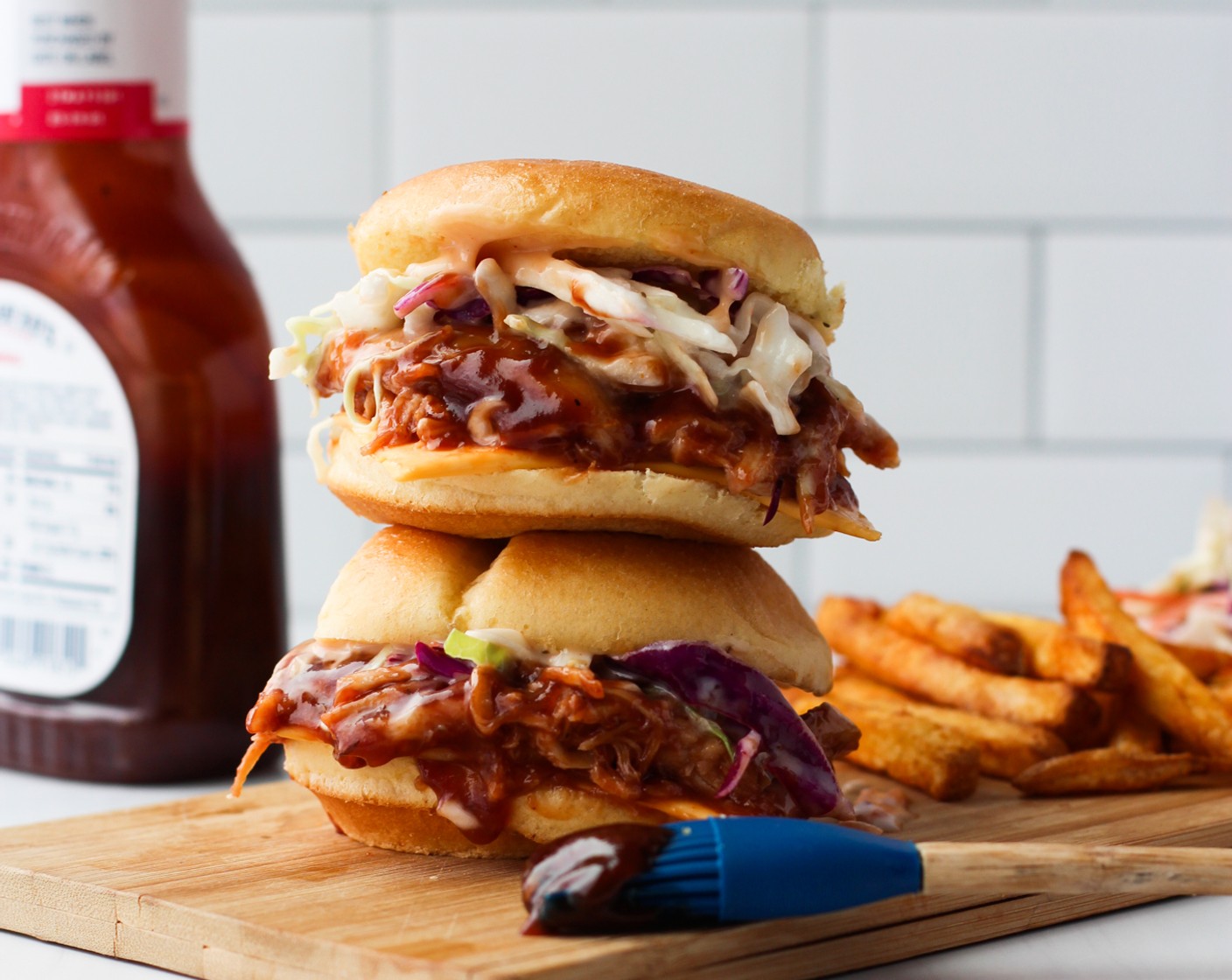 step 4 Layer Cheddar Cheese (6 slices) slice, barbecue chicken and slaw mixture on Hawaiian Rolls (12). Top with extra barbecue sauce if desired, serve with french fries and leftover slaw on the side.