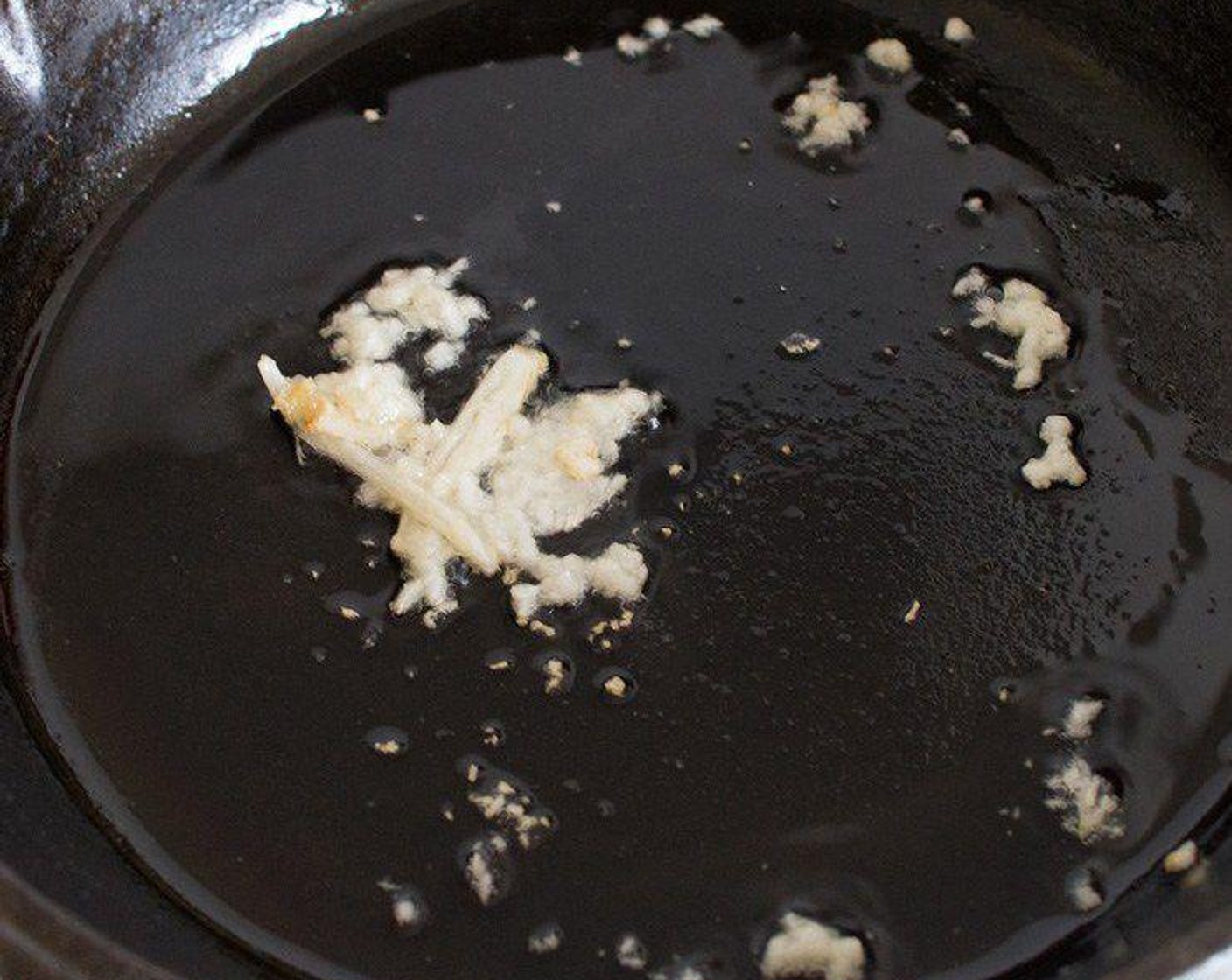 step 2 Heat a generous splash of Oil (as needed) over low heat in a large, non-stick frying pan, add the Garlic (1 clove) and fry for 2-3 minutes until the garlic turns slightly golden in color.