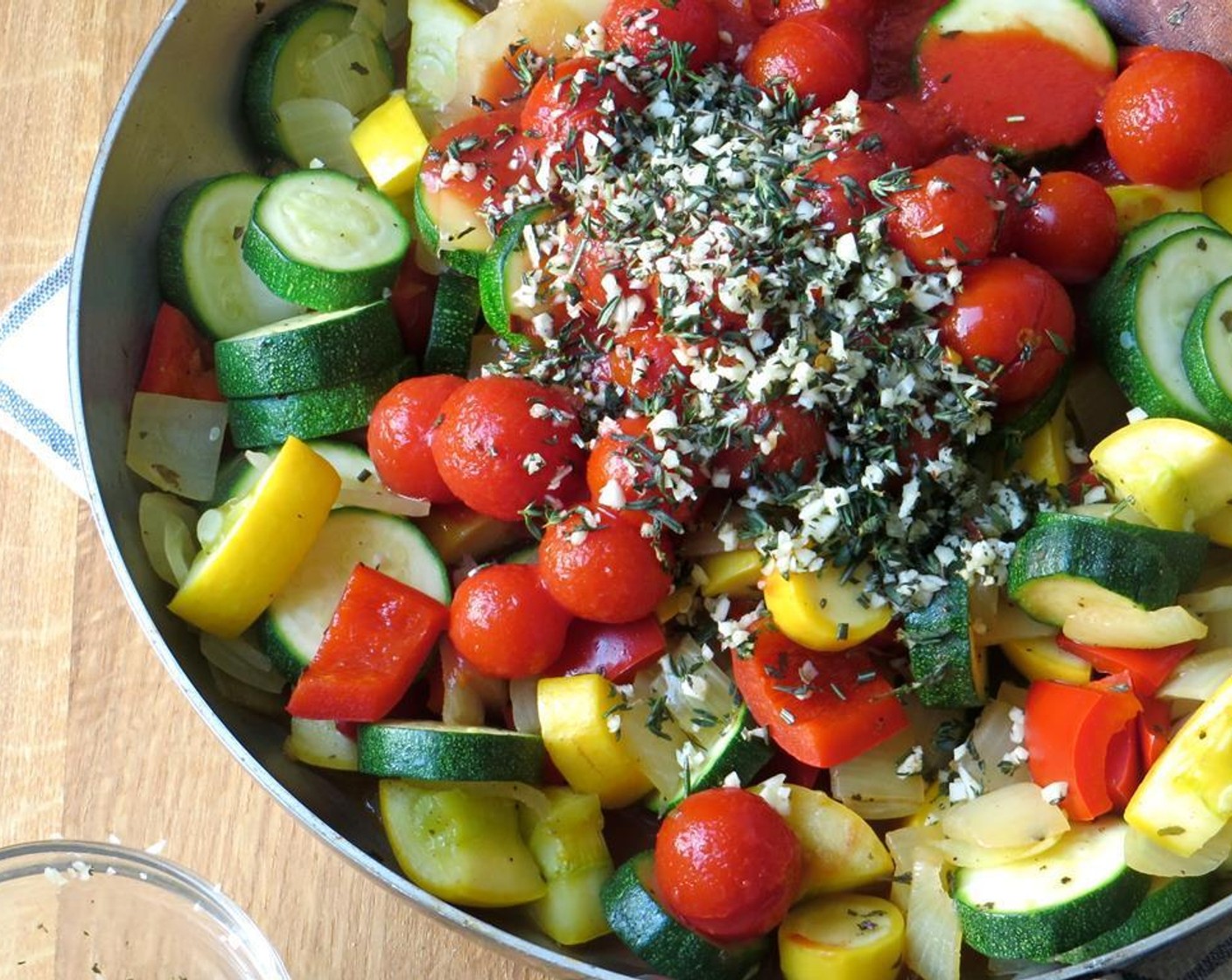 step 6 Open and add the Cherry Tomato (1), garlic/herb mixture, Crushed Red Pepper Flakes (1/8 tsp), and Dried Basil (1 tsp), and stir to blend. Cook an additional 8 to 10 minutes with the lid on the pan, stirring occasionally.