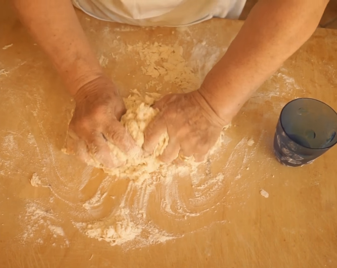 step 2 While doing this, bring the edges of the flour into the center with the fork, and quickly continue to cover the egg all the way around. Once all flour is incorporated, add a little bit of Water (as needed), and use your hands to start kneading the dough.