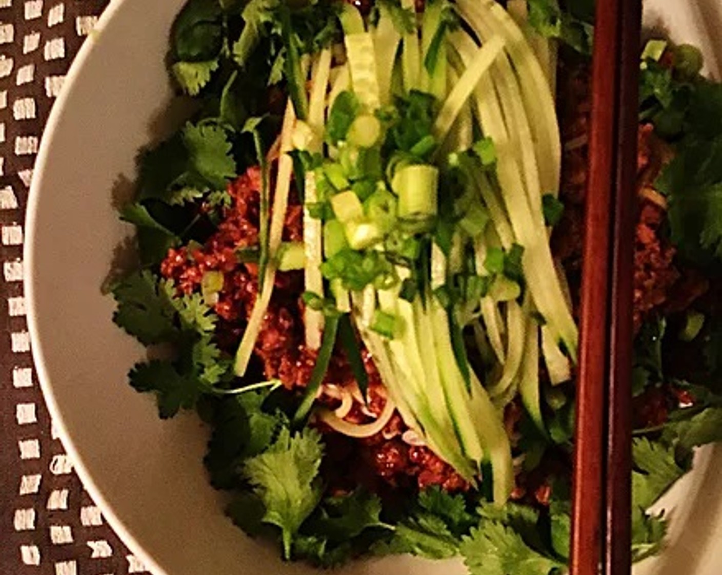 step 11 When the sauce is done, generously ladle it into the bowl with your cooked noodles.  Topped with chopped cucumbers, cilantro and scallions. Enjoy!