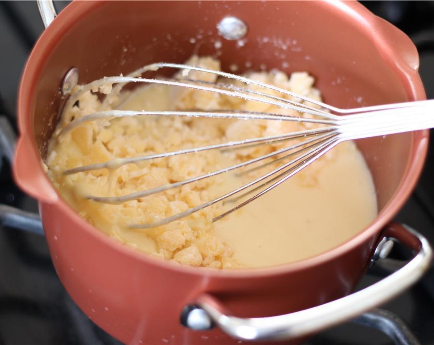 step 4 Slowly add the cheese mixture, whisking as it melts.