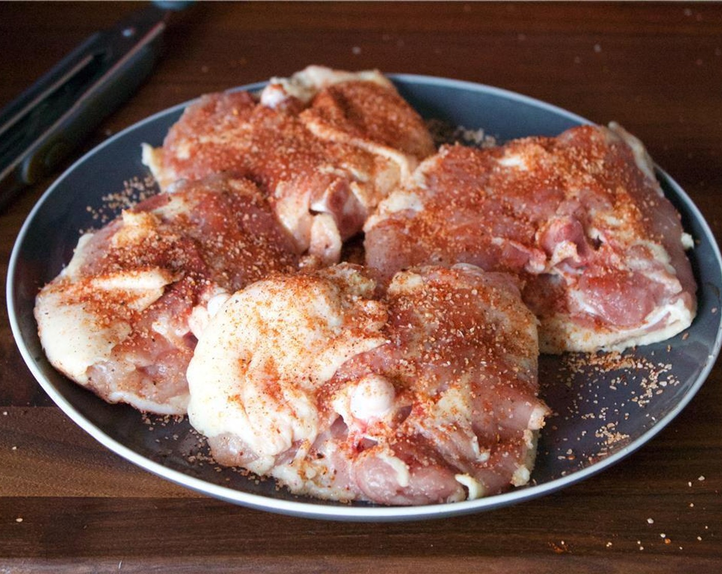 step 6 Combine the Kosher Salt (1 tsp), crushed Ground Black Pepper (1/2 tsp) and Smoked Paprika (1/2 tsp), and liberally season the Chicken Thighs (4) on both sides.