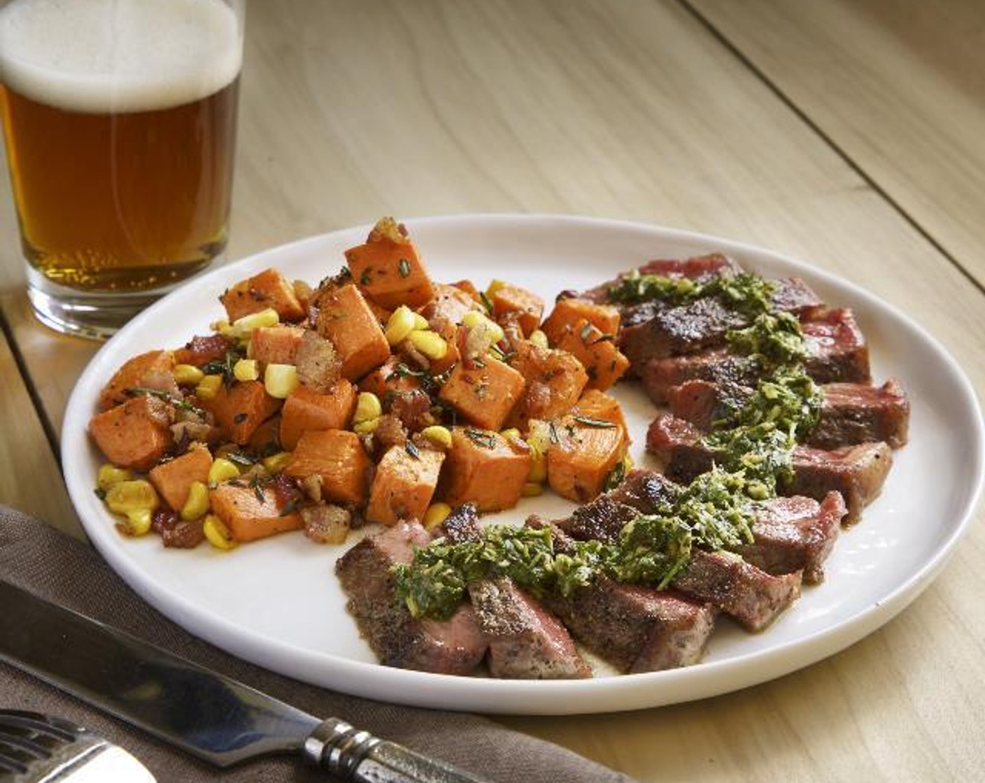 step 18 Cut the steaks into 1/4 inch slices. Divide the sweet potato hash evenly between two plates. Fan the steak slices out next to the hash. Spoon the chimichurri over the steak.