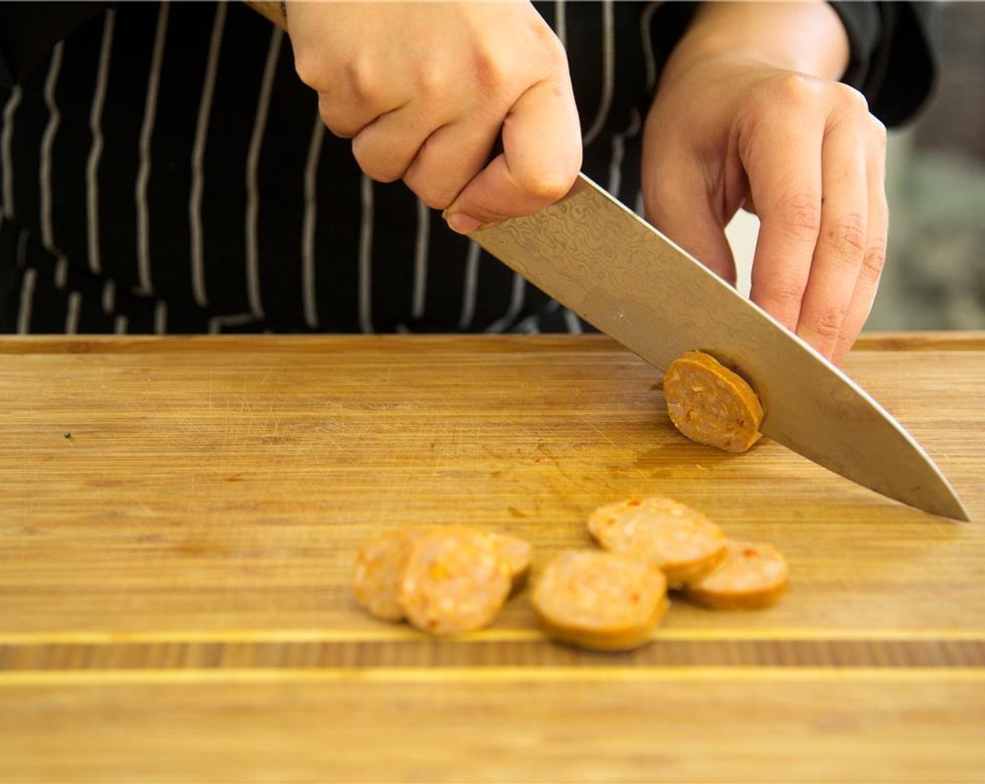 step 1 Slice the Spanish Chorizo (2) into quarter inch circles, and set aside.