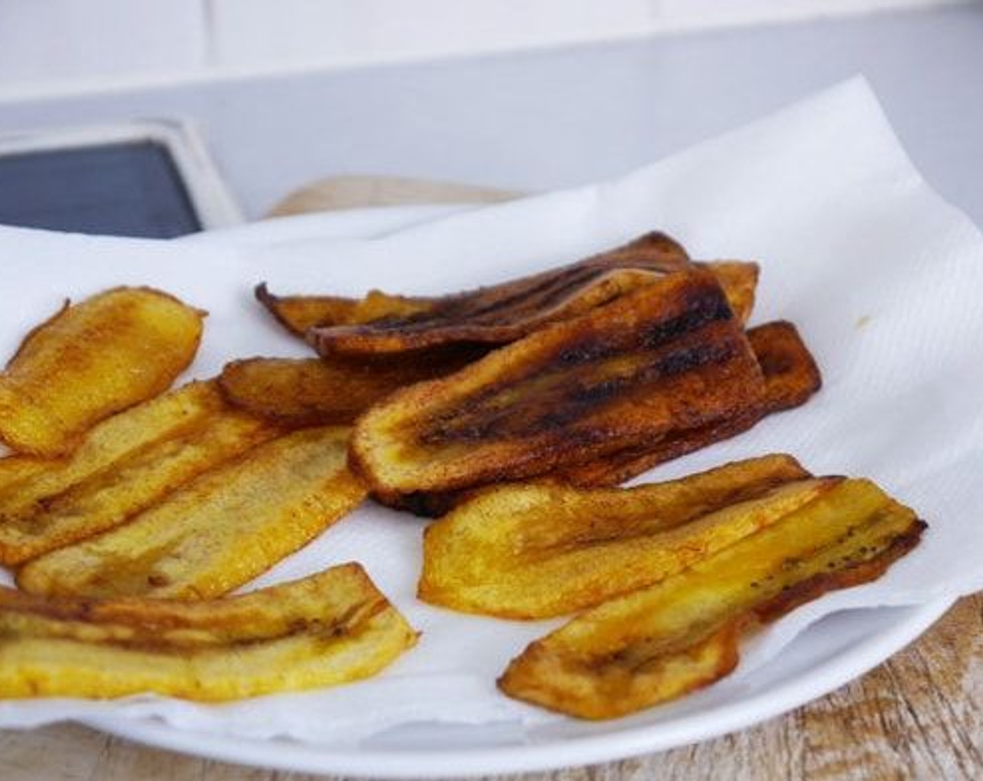 step 7 When the plantain is brown remove from the pan and place on a plate with kitchen paper to absorb the extra oil. Serve with Fresh Cilantro (to taste) and Feta Cheese (to taste).