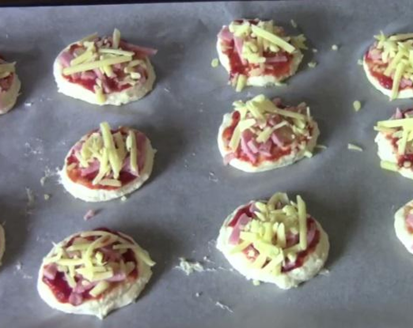 step 2 Kneed the dough on a floured surface for about 2 minutes. Roll the dough into a flat disk. Using a cookie cutter,cut the dough into small pieces,and top each dough with Tomato Sauce (to taste), Canned Pineapple Slices in Juice (to taste), and Ham (to taste).