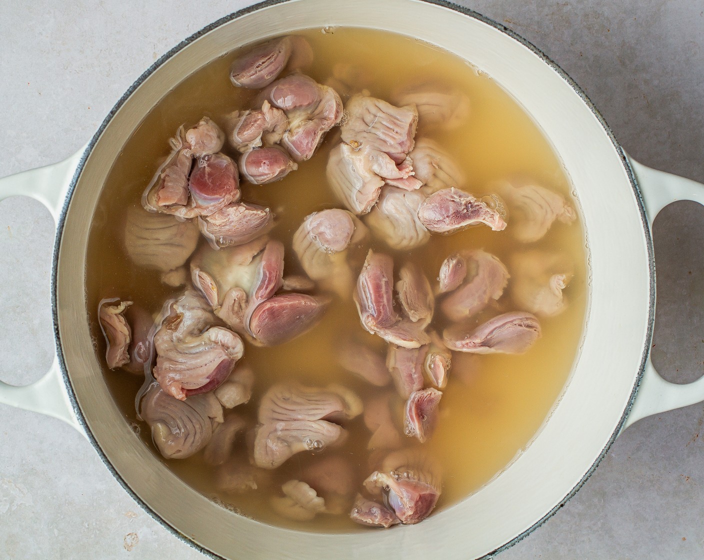 step 1 To a large, heavy bottom pot or Dutch oven over high heat add the Chicken Gizzards (1 lb), Kosher Salt (1/2 Tbsp), and Water (5 cups). Bring to a boil, then reduce to a simmer and cover for 30 minutes. Skim foam off the water as gizzards cook. Use a slotted spoon to remove the gizzards and reserve 3 cups of stock in a separate container.