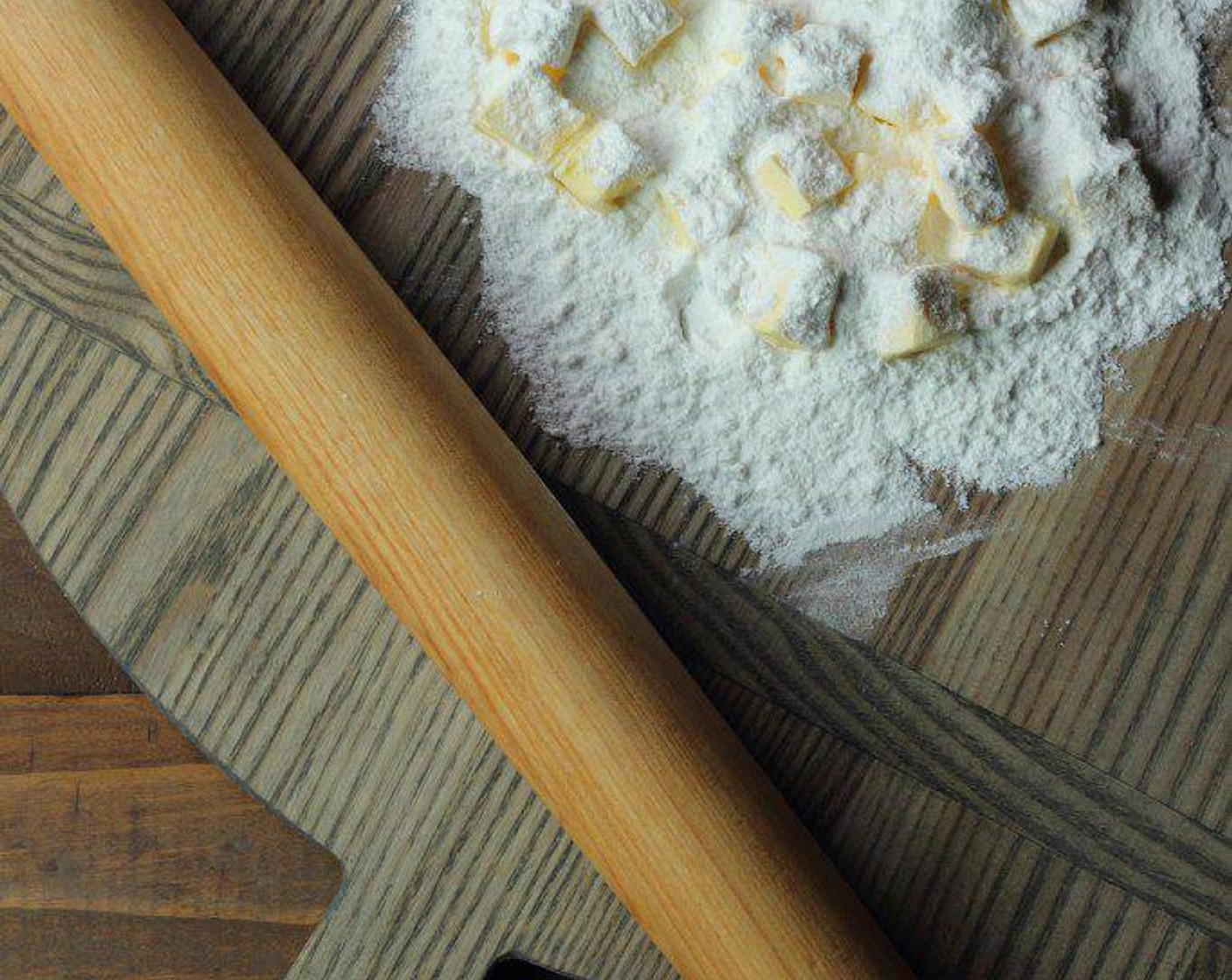 step 3 Scoop some flour onto a cutting/pastry board, add chilled butter to flour, then add more flour on top of butter.