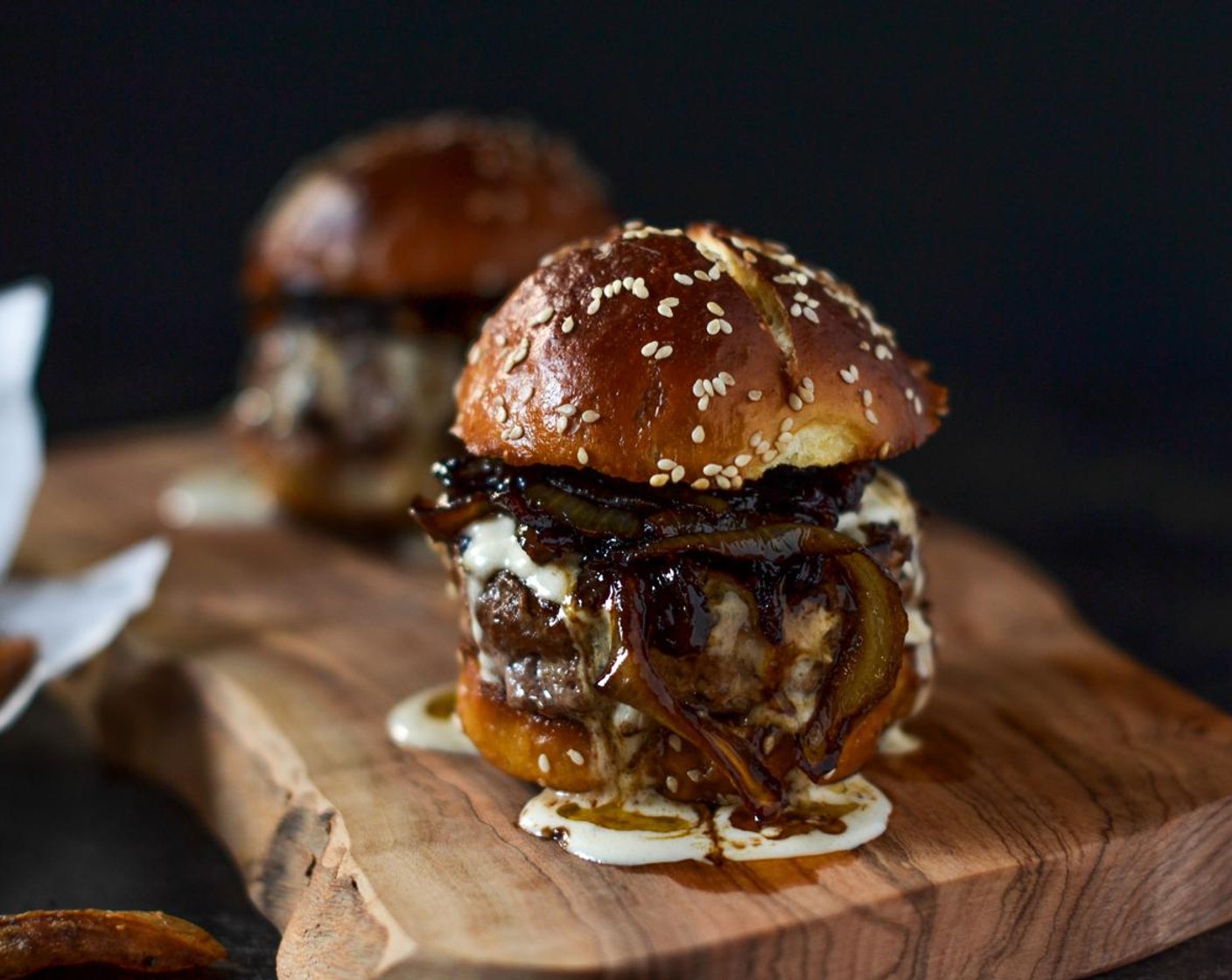 step 8 To assemble your burger, simply start off with your patty, topped off with a generous helping of sticky onions and a good dollop of the blue cheese sauce.  Top with the second bun and prepare for a monster mouthful that’s full of smokey richness!