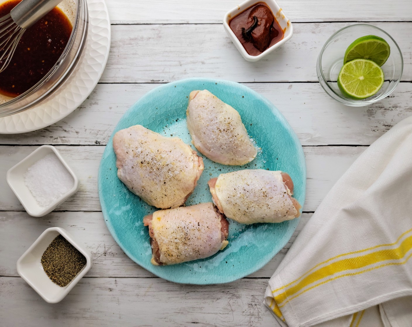 step 3 Pat the chicken thighs dry with paper towels. Sprinkle the Bone-in, Skin-on Chicken Thighs (2 lb) all over with Kosher Salt (1/2 Tbsp) and Ground Black Pepper (1/2 Tbsp).