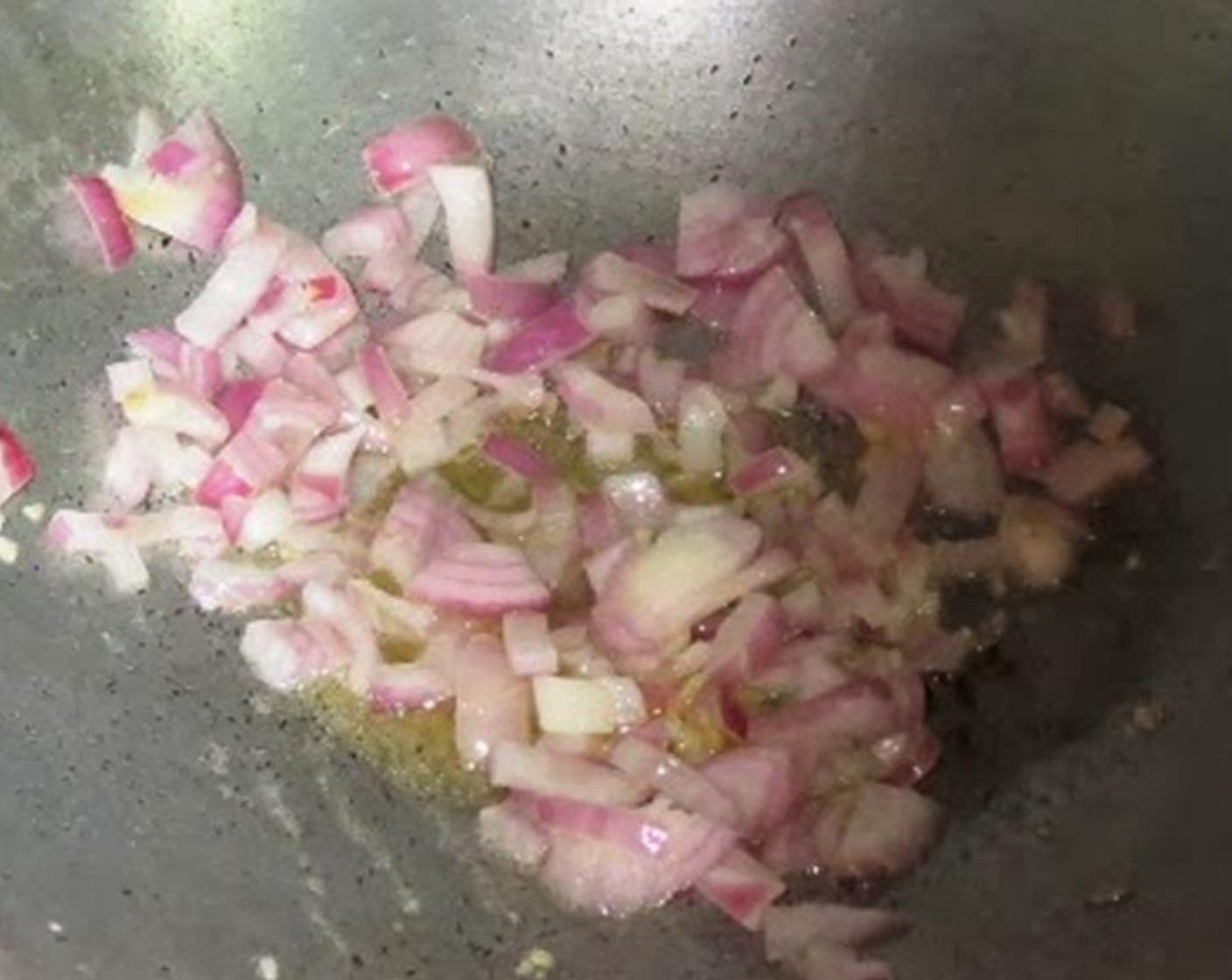step 3 Heat Olive Oil (1/2 Tbsp) in a pan and add garlic and onion. Cook for a minute on high or until they are translucent.