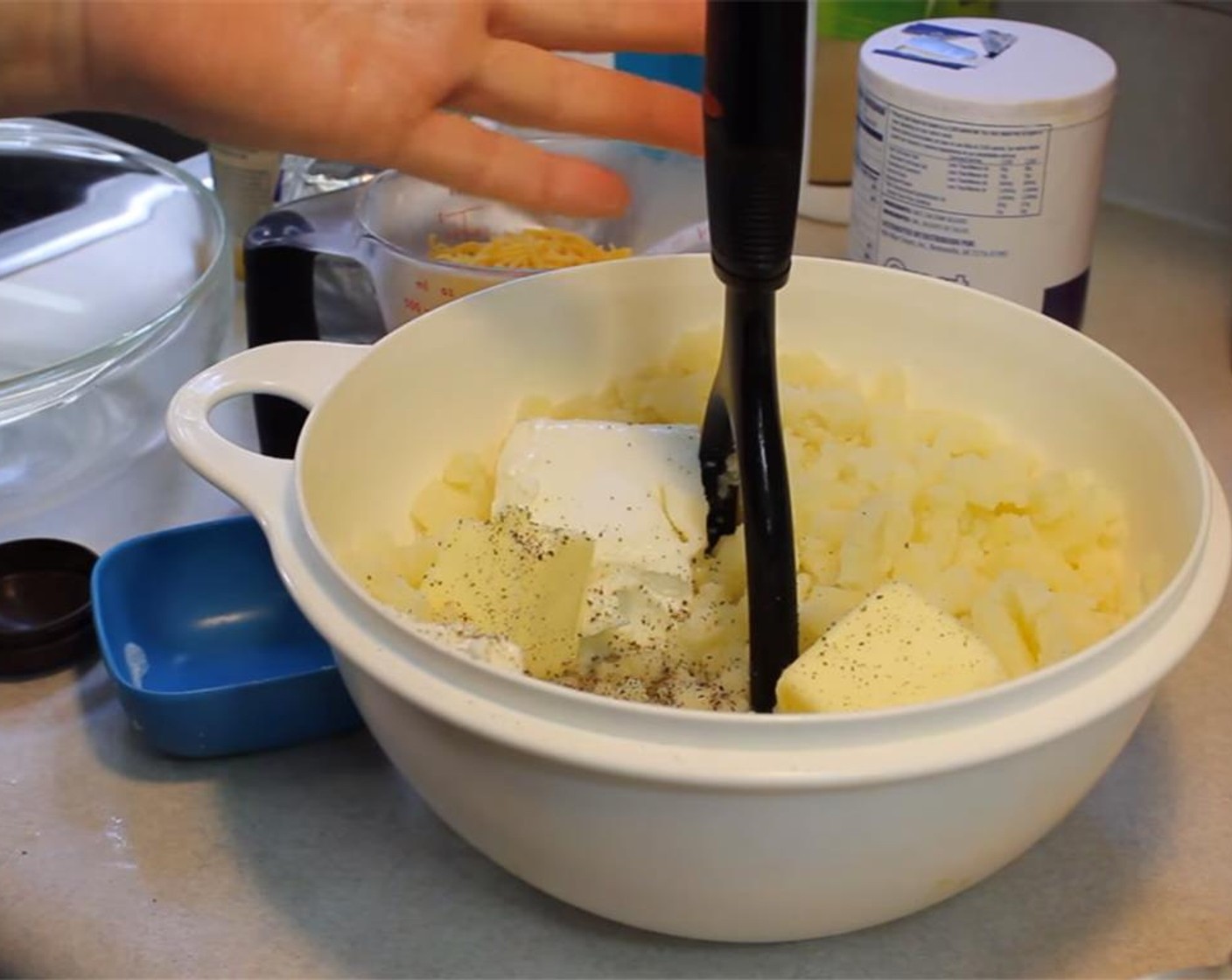 step 3 Transfer potatoes to a saucepan. Mash with a potato masher until almost smooth. Add Cream Cheese (1/2 cup), Sour Cream (1/2 cup), Butter (1/4 cup), Milk (1/4 cup), Salt (1 tsp) and Ground Black Pepper (1/2 tsp). Continue mashing until smooth.