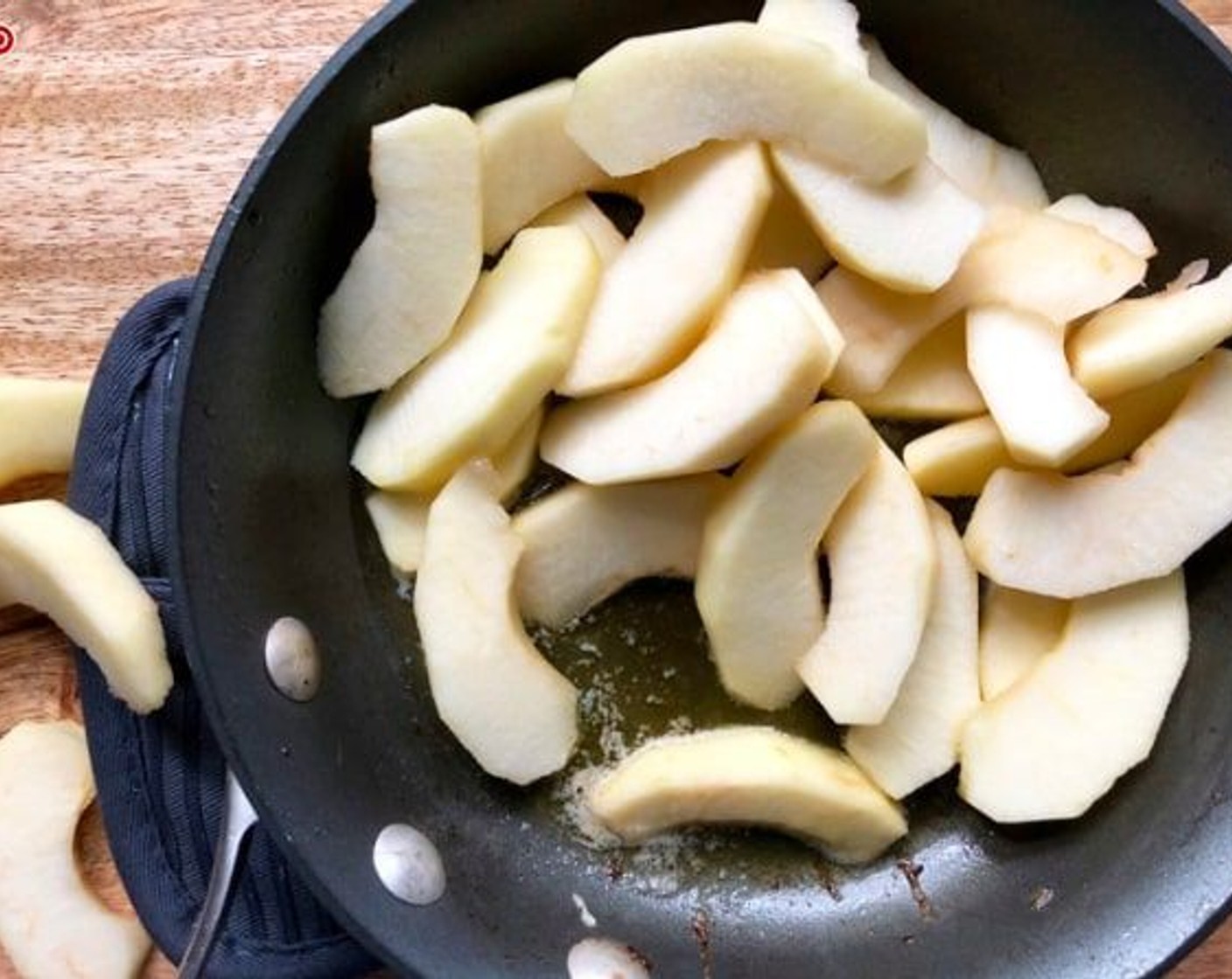 step 7 Add Unsalted Butter (1 tablespoon) and Olive Oil (1/2 tablespoon) to skillet, then add the Pink Lady Apples (2).